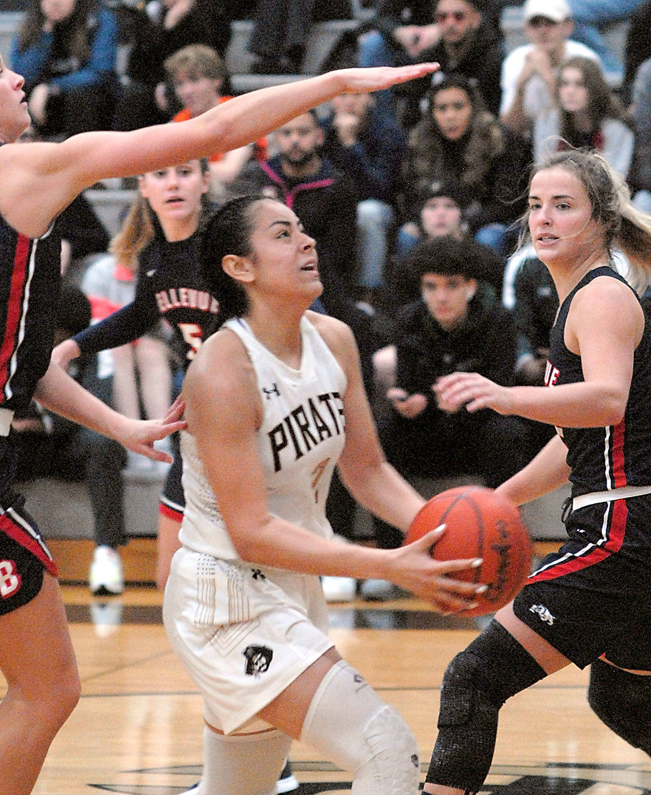 Peninsulas Leillani Padilla, center, is surrounded by the Bellevue defense of, from left, Rokki Brown, Natalie Amos and Makenna Faulkner on Wednesday on the Pirate home court in Port Angeles. (Keith Thorpe/Peninsula Daily News)