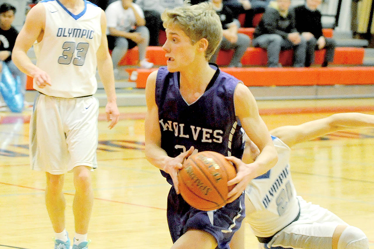 Sequims Erik Christiansen moves with the ball during the Wolves 59-47 loss to Olympic on Saturday, Feb. 8, 2020, in a playoff tiebreaker at Port Townsend High School. (Conor Dowley/Olympic Peninsula News Group)