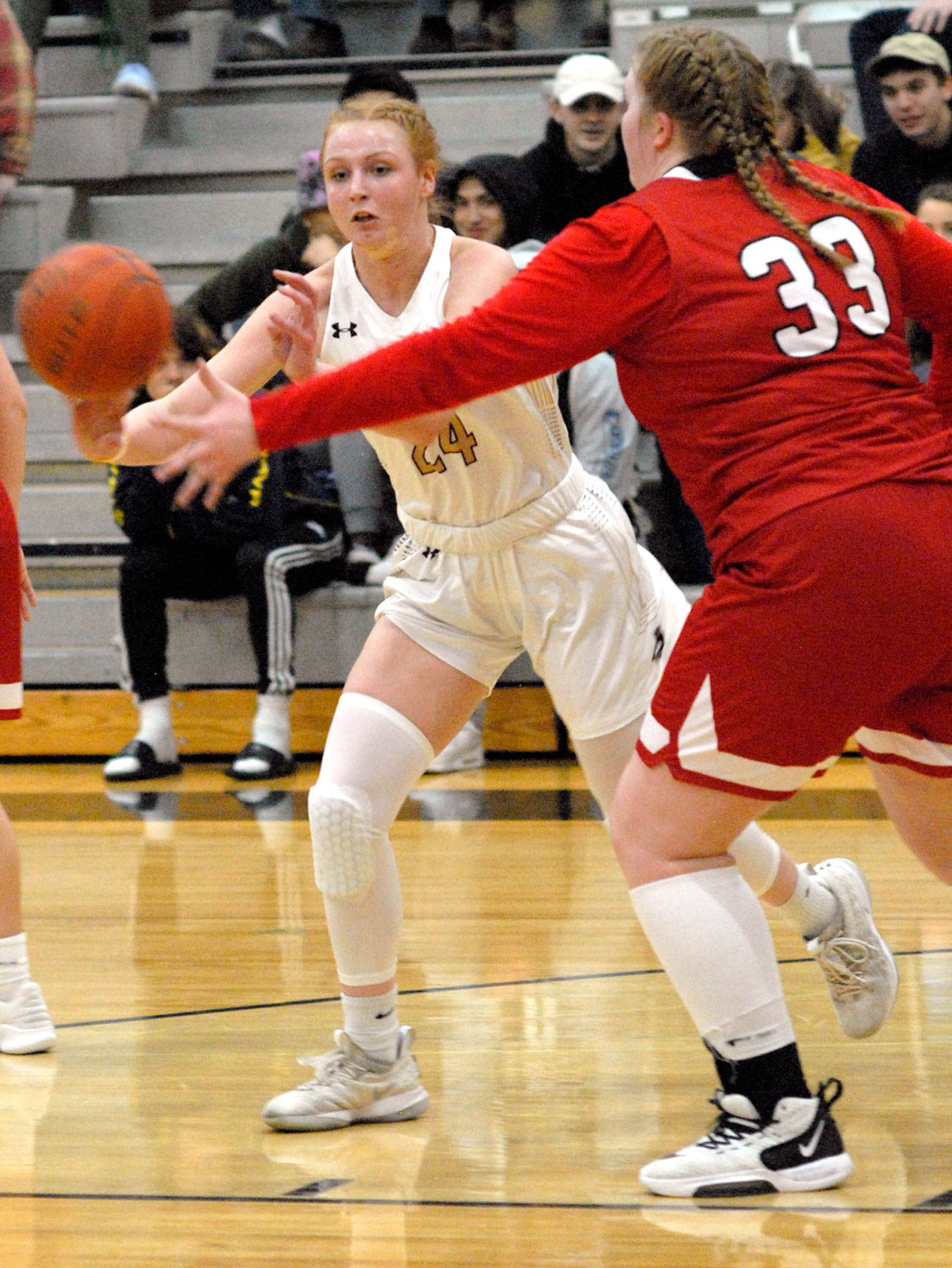 Keith Thorpe/Peninsula Daily News Peninsulas Kameron Bowen, left, makes a pass as Skagit Valleys Melissa Frein defends on Wednesday night in Port Angeles.