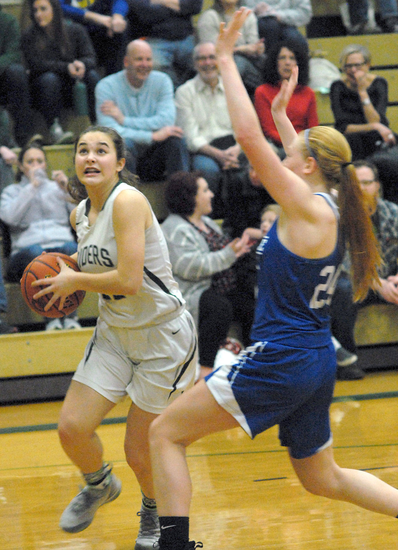 Keith Thorpe/Peninsula Daily News Port Angeles’ Eve Burke, front, avoids the defense of Eatonville’s Kya Stewart during Friday’s playoff game at Port Angeles High School.