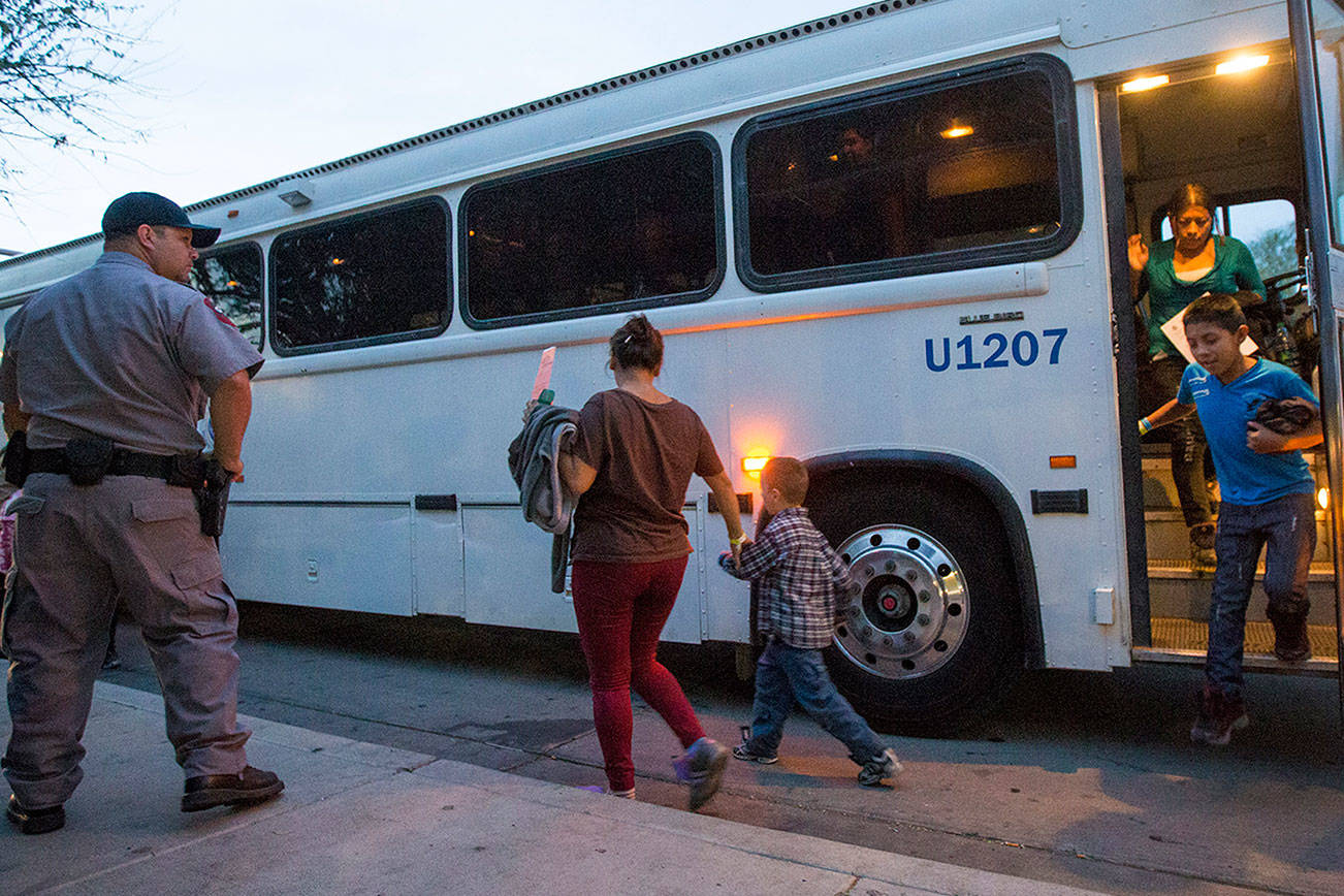 In this May 28, 2014, file photo, migrants are released from ICE custody at a Greyhound bus station in Phoenix. A Customs and Border Protection memo dated Jan. 28, 2020, obtained by The Associated Press confirms that bus companies such as Greyhound do not have to allow Border Patrol agents on board to conduct routine checks for illegal immigrants, despite the company’s insistence that it has no choice but to do so. (Michael Chow/The Arizona Republic via AP)