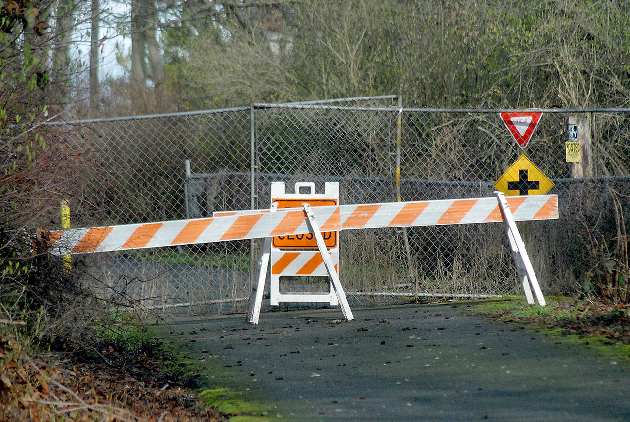 A barricade and construction fencing block access to a portion of the Waterfront Trail, part of the Olympic Discovery Trail, near Four Seasons Ranch on Saturday, Feb. 15, 2020, near the area where Native American burial remains were discovered in January. Weather damage to the trail has delayed opening of the popular trail. (Keith Thorpe/Peninsula Daily News)
