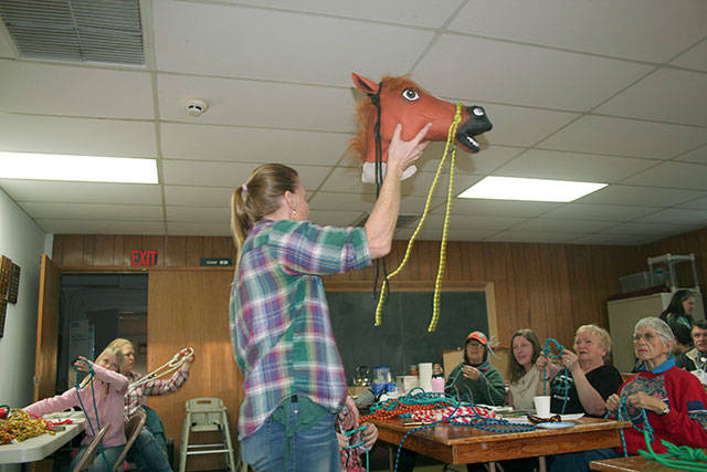Sequim author, endurance rider and entrepreneur Lisa Preston explained how to make a bitless bridle called a side-pull to a packed house of horse-loving folks during a recent Bitless Bridle workshop hosted by the Peninsula Chapter of Back Country Horsemen of Washington. (Karen Griffiths/for the Peninsula Daily News)