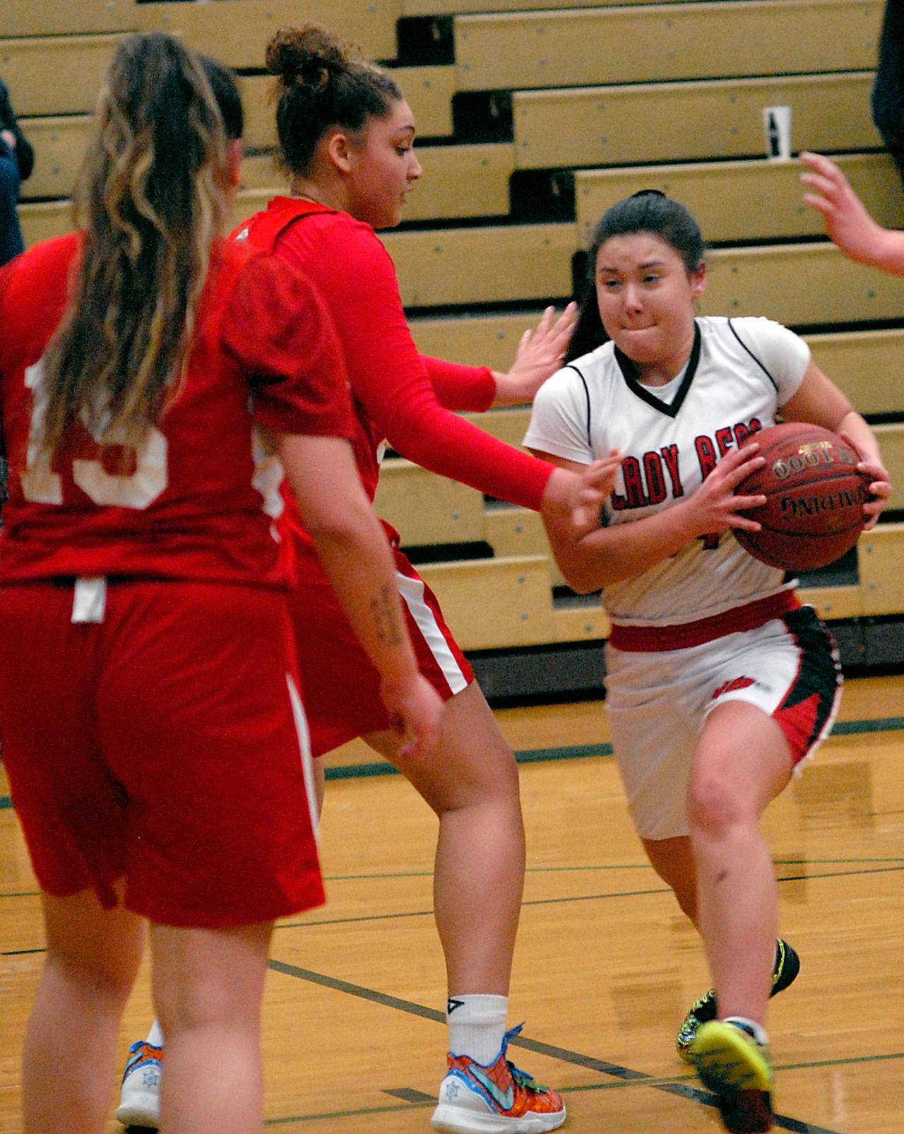Neah Bay’s Ruth Moss, right, drives to the lane as Tulalip Heritage’s Claudia Parker, left, and Jacynta Mules-Gilford defend on Tuesday at Port Angeles High School. (Keith Thorpe/Peninsula Daily News)