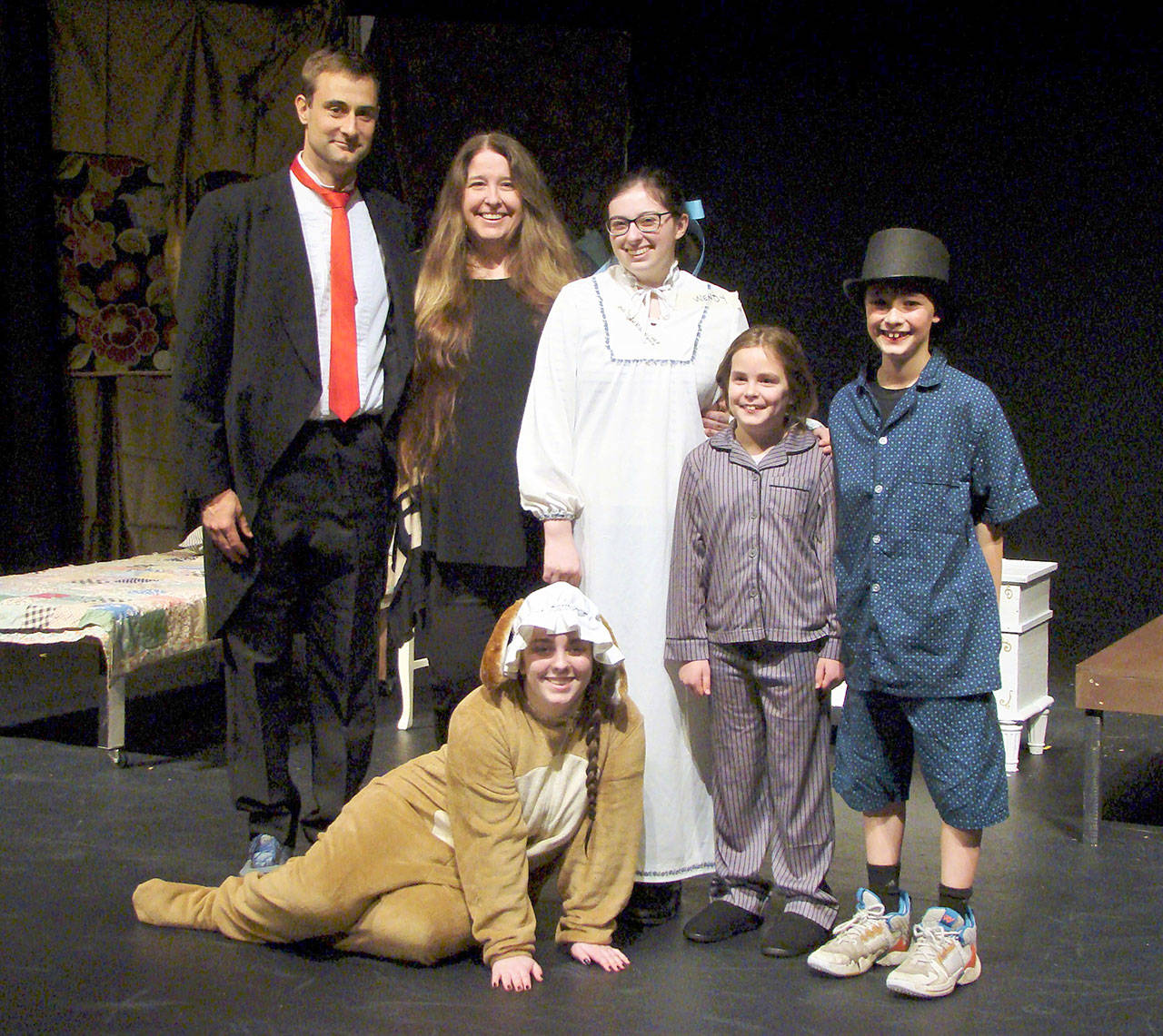 The Darling Family are, from left, Reed Wendel as Mr. Darling; Brandi Welch as Mrs. Darling; Madelyn Pickens as Wendy; Julia Rutledge as Michael; Henry Wendel as John; and, in front, Zoie Harris as Nana. (Amy McIntyre)