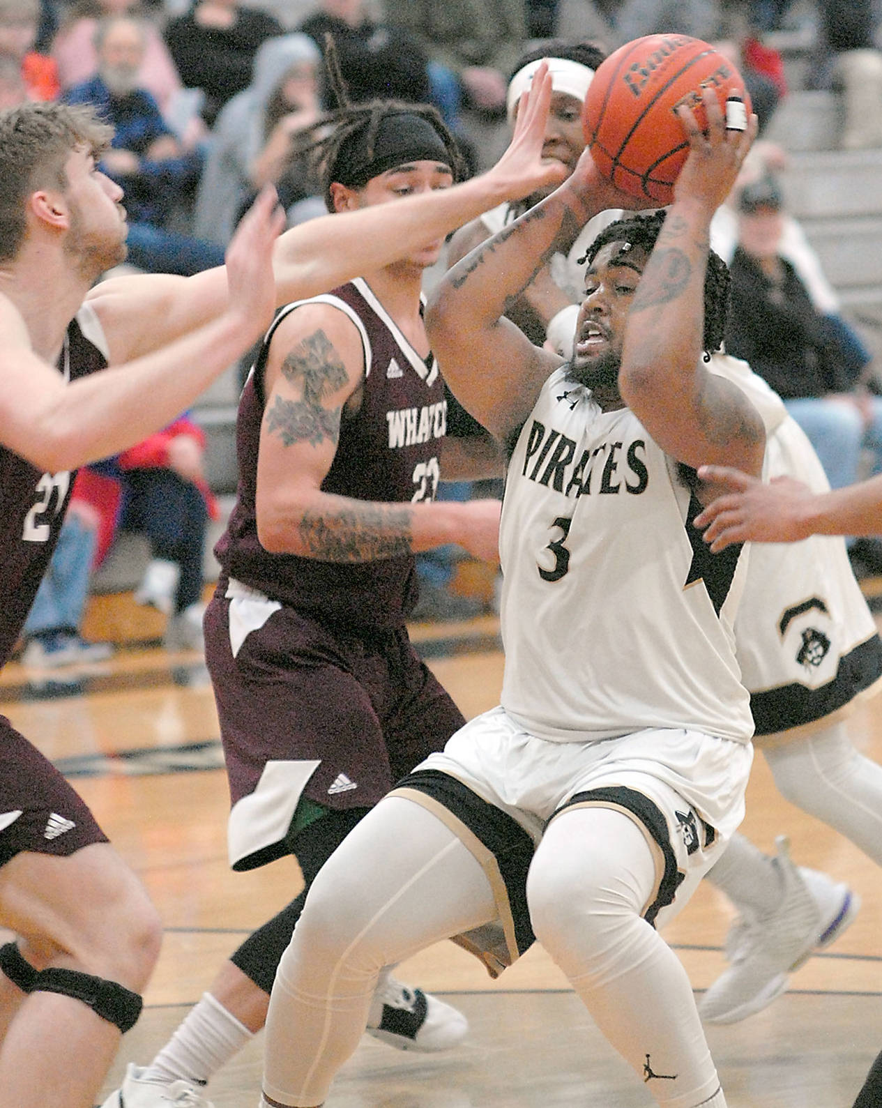 Peninsula’s Davien Harris-Williams, right, is surrounded in the lane by Whatcom’s Spencer Martin, left, and Marcus Montag in Wednesday night’s NWAC North Region game in Port Angeles. (Keith Thorpe/Peninsula Daily News)