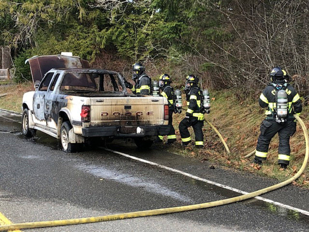 Clallam County Fire District No. 2 crews extinguish a vehicle fire near Dry Creek Elementary School west of Port Angeles on Monday. (Chief Jake Patterson/Clallam 2 Fire Rescue)