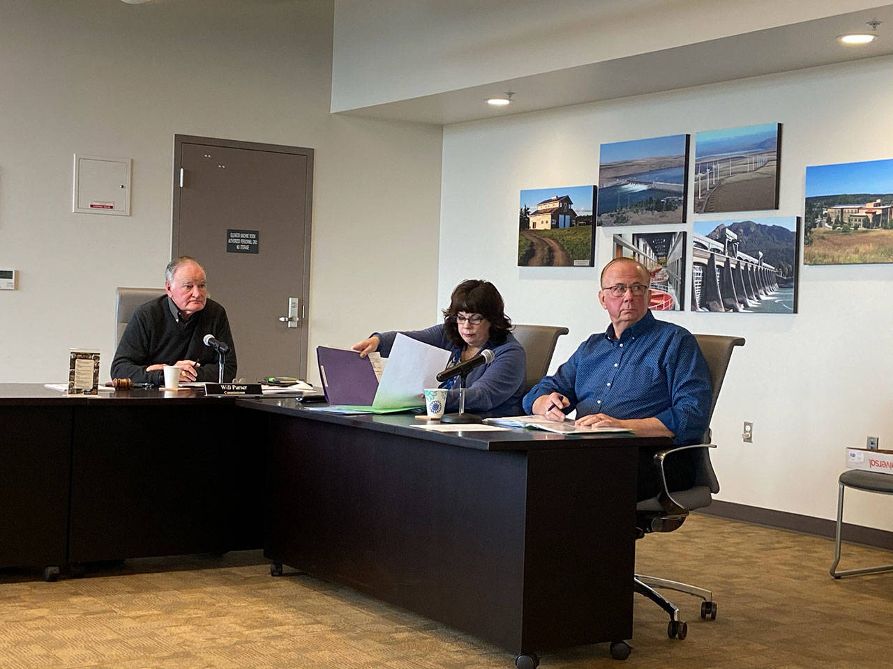 Clallam County Public Utility District Commissioner Will Purser, left, Executive Assistant Teresa Lyn and General Manager Doug Nass are seen in a Monday, Feb. 24, 2020, meeting at the PUD headquarters in Carlsborg. (Rob Ollikainen/Peninsula Daily News)