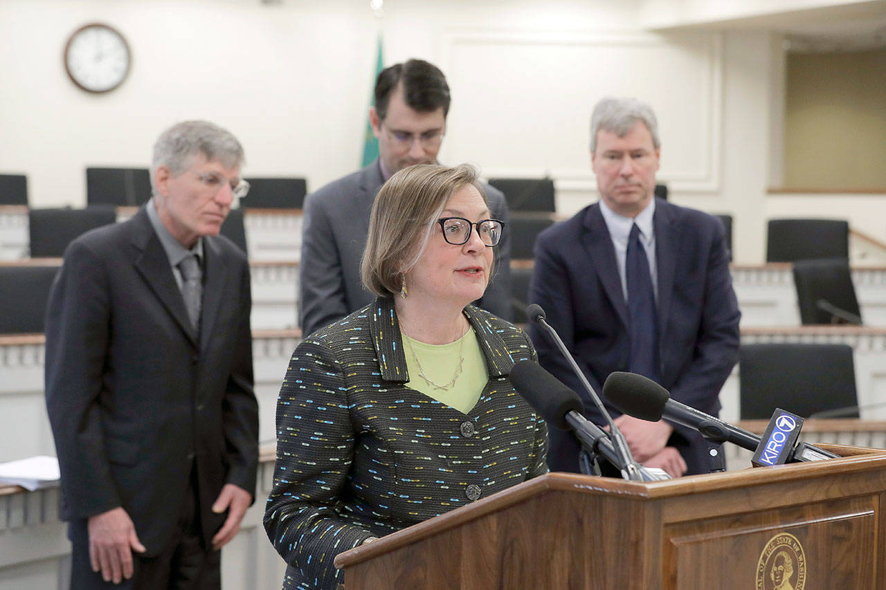 Rep. June Robinson, D-Everett, vice chairwoman of the House Appropriations Committee, center, stands with other lawmakers as they talk about the release of their supplemental budget, Monday, Feb. 24, 2020, before a news conference at the Capitol in Olympia. Both House and Senate Democrats unveiled plans Monday that would increase state spending to address affordable housing and homelessness programs throughout the middle of 2021. (Ted S. Warren/The Associated Press)