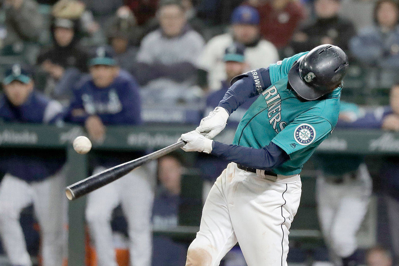 Seattle Mariners’ J.P. Crawford hits a walk-off RBI double in the ninth inning against the Oakland Athletics to score Shed Long and give the Mariners a 4-3 win over the Oakland Athletics in a baseball game Friday, Sept. 27, 2019, in Seattle. (Ted S. Warren/The Associated Press)