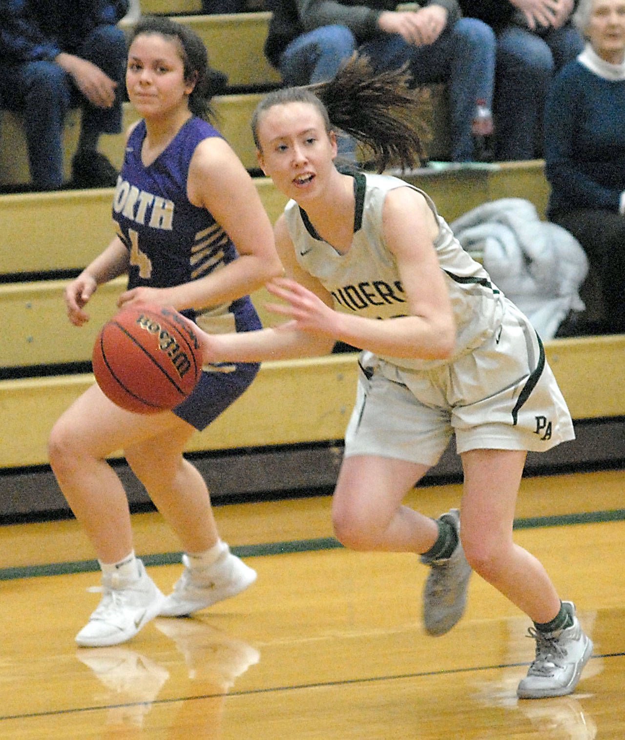 Port Angeles’ Mikkiah Brady, right, dribbles by North Kitsap’s Noey Barreith during a January game at Port Angeles High School. (Keith Thorpe/Peninsula Daily News)
