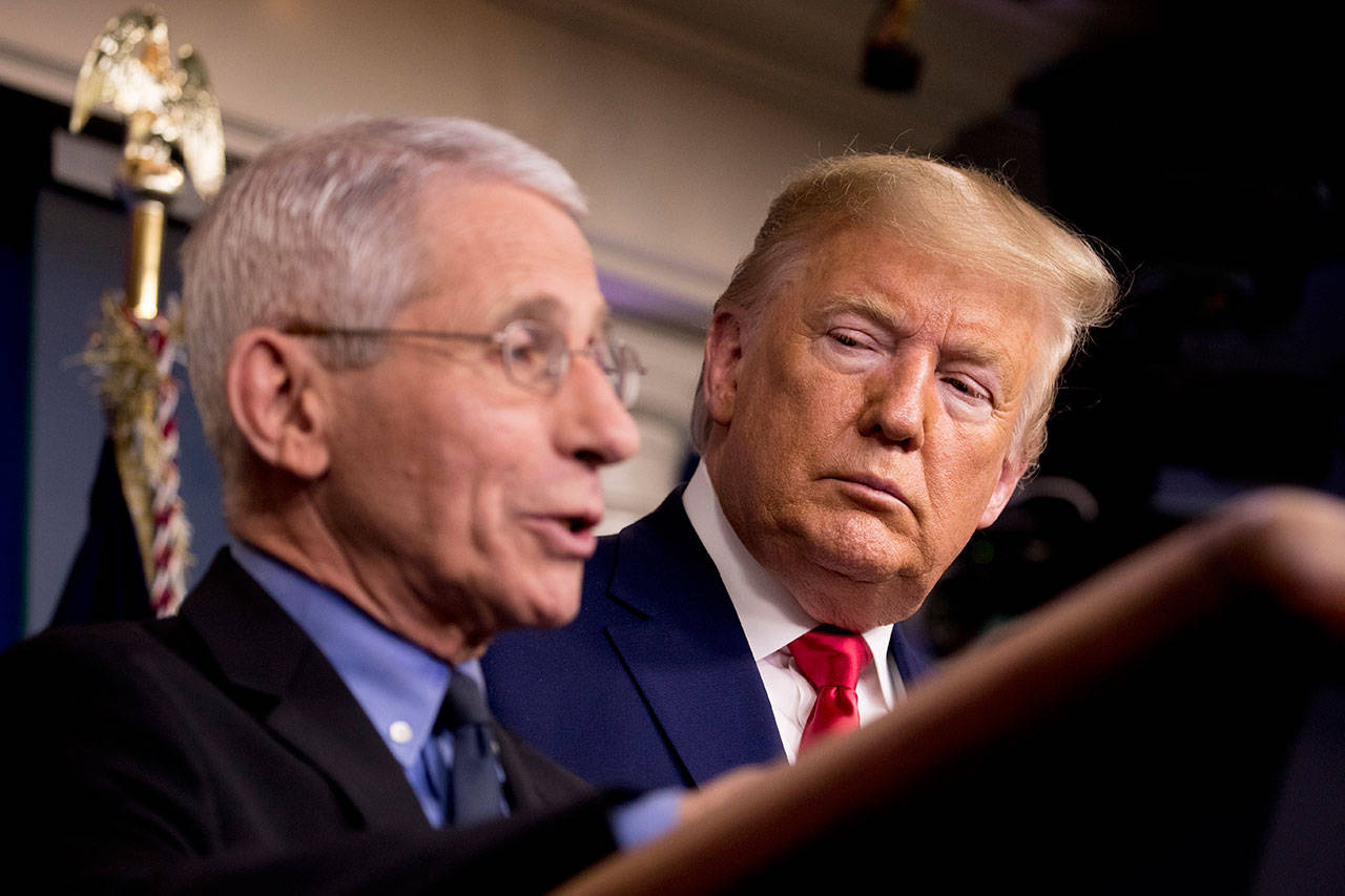 National Institute for Allergy and Infectious Diseases Director Dr. Anthony Fauci, left, accompanied by President Donald Trump, speaks about the coronavirus during a news conference in the press briefing room at the White House, Saturday. (AP Photo/Andrew Harnik)