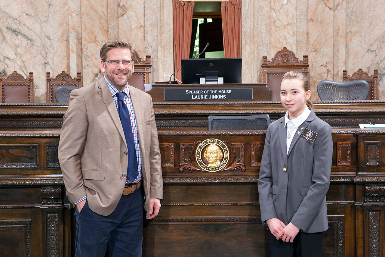 State House page Eryn Brown-Munn poses for a photo with her sponsor, Rep. Mike Chapman. (Washington State Legislative Support Services)