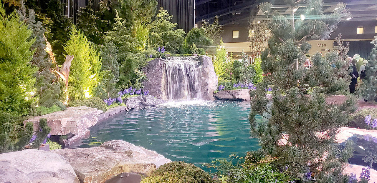 A breathtaking waterfall and pond is one of the many spectacular displays at the Northwest Flower and Garden Show. (Andrew May/For Peninsula Daily News)