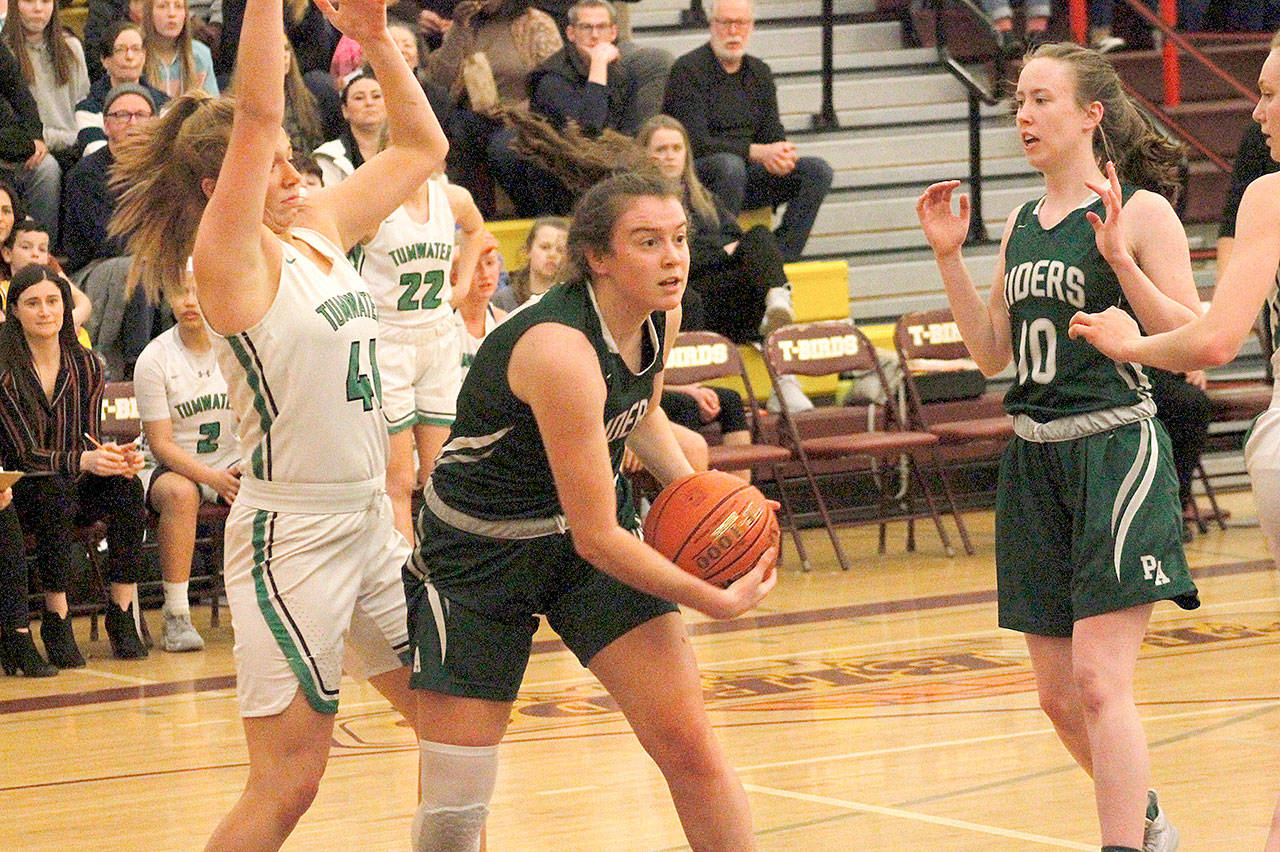 Port Angeles Jaida Wood looks to pass against Tumwater in the Roughriders 58-57 loss Saturday at Mount Tahoma High School. At right is the Riders Mikkiah Brady. (Mark Krulish/Kitsap News Group)