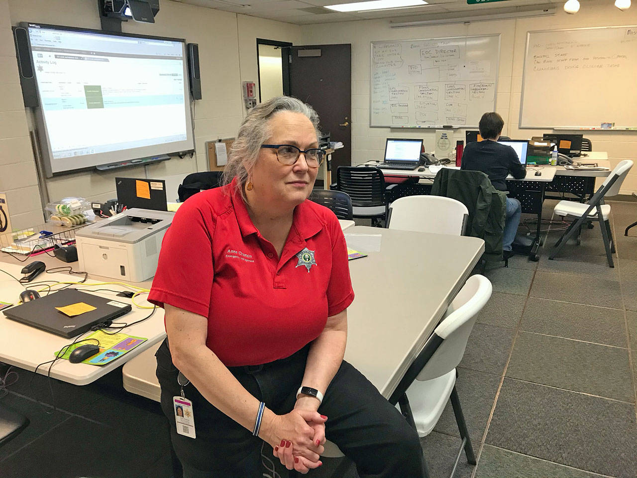 Anne Chastain, Clallam County Emergency Management Center coordinator, staffing the EOC on Monday, March 2, 2020, said only people who have flu- or cold-like symptoms should wear surgical masks in public, not people who are otherwise healthy. (Paul Gottlieb/Peninsula Daily News)