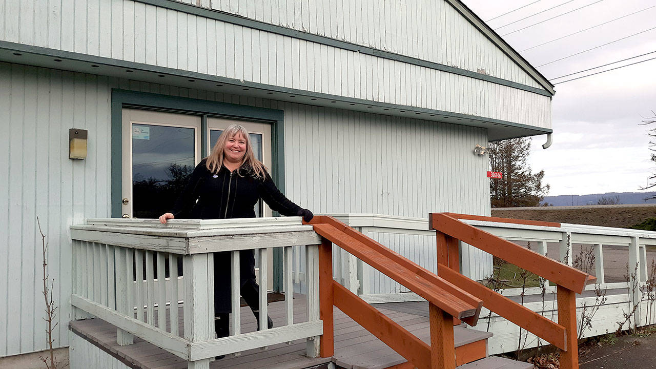 Hood Canal Adventures owner and CEO Christina Maloney stands in-front of the office space at the Brinnon Community Center where the storefront of Hood Canal Adventures will soon be located. (Hood Canal Adventures)