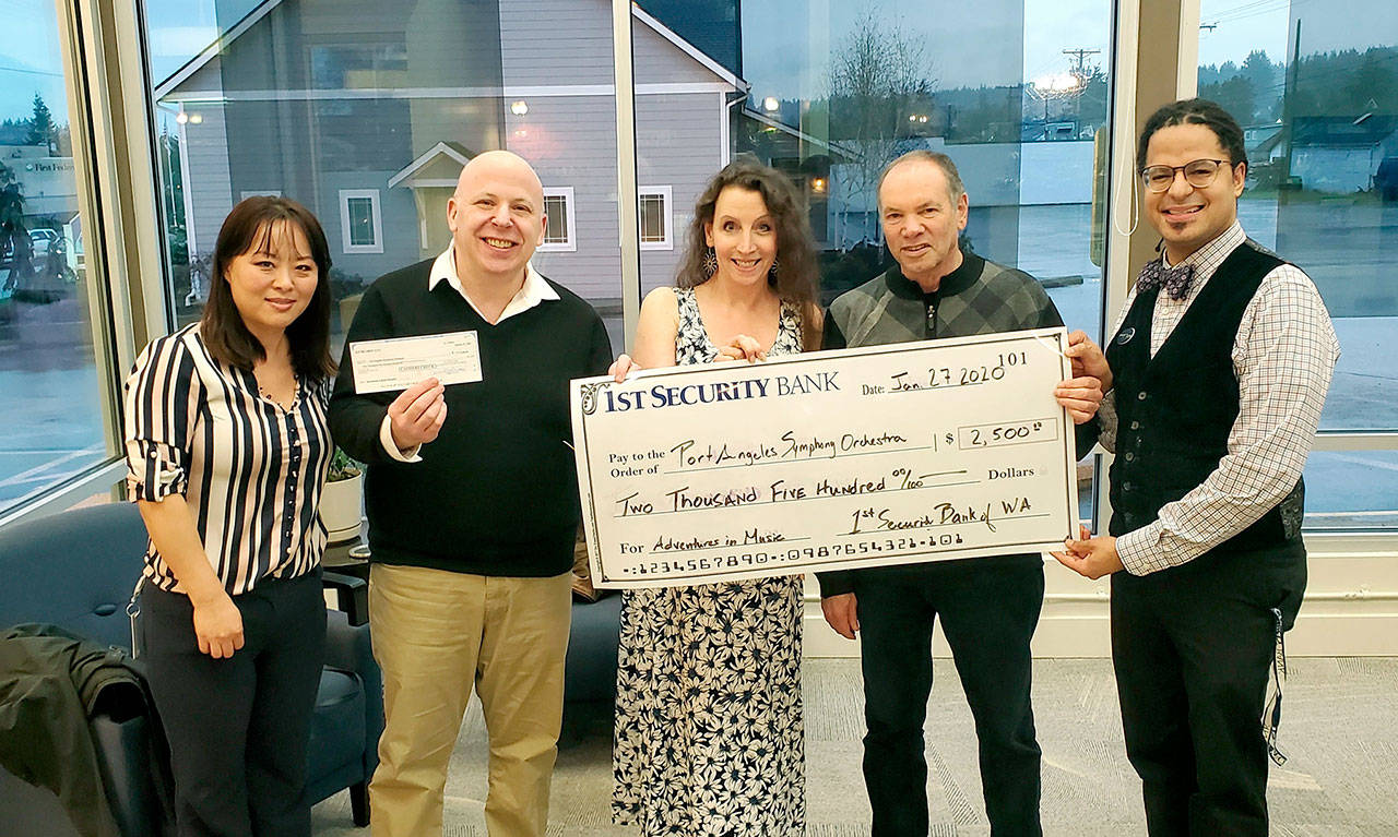 Celebrating First Security Bank’s grant to the Adventures in Music program are, from left, bank staff member Rui Starrett, Port Angeles Symphony conductor Jonathan Pasternack, Symphony board member Lisa Harvey-Boyd, AIM director Al Harris and bank officer-Symphony violist Tyrone Beatty.