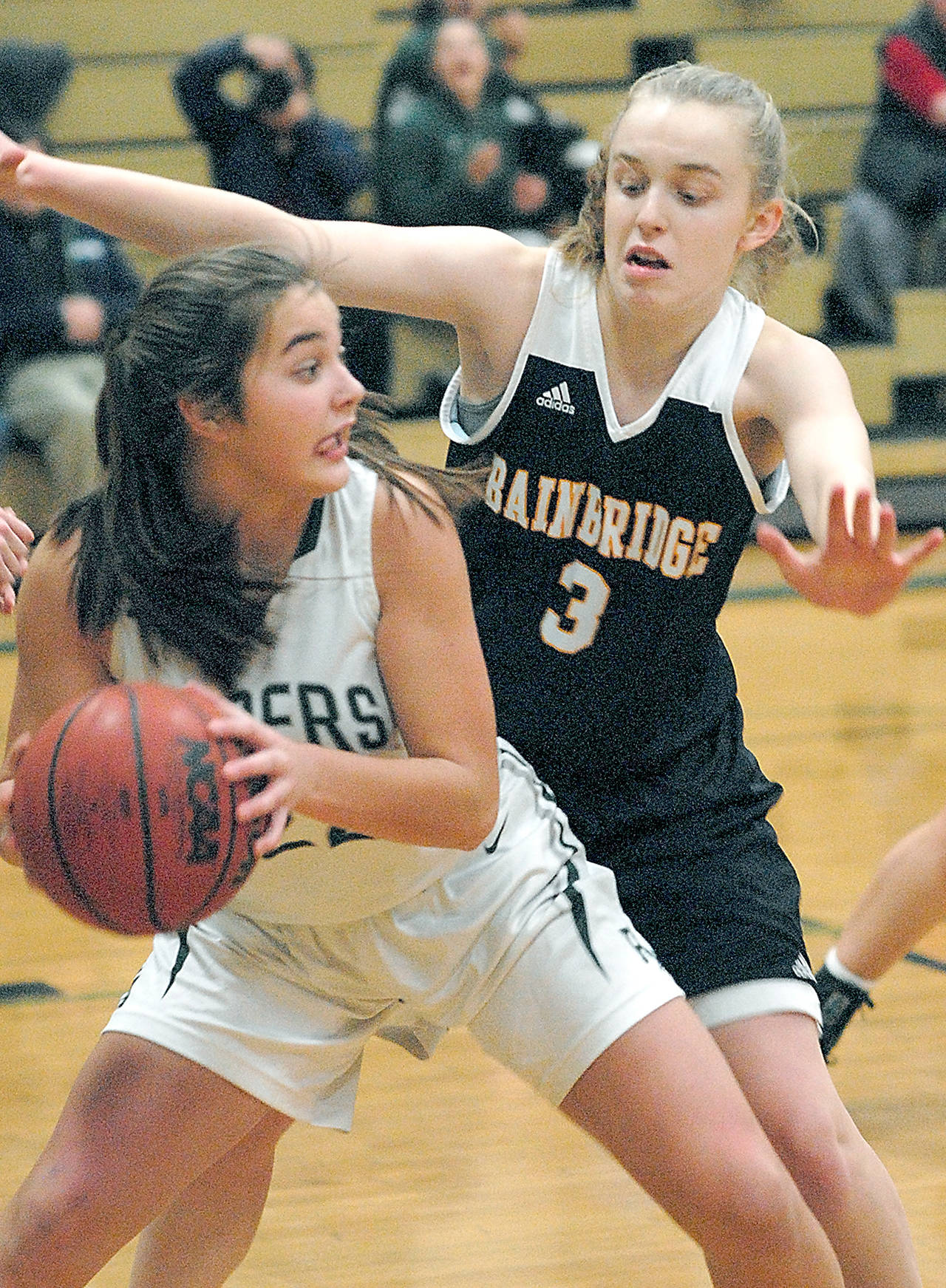 Port Angeles’ Eve Burke, left, scored 18 points and grabbed eight rebounds in Wednesday’s state win over a Clarkston team with four players 5-foot-11 or taller. (Keith Thorpe /Peninsula Daily News)