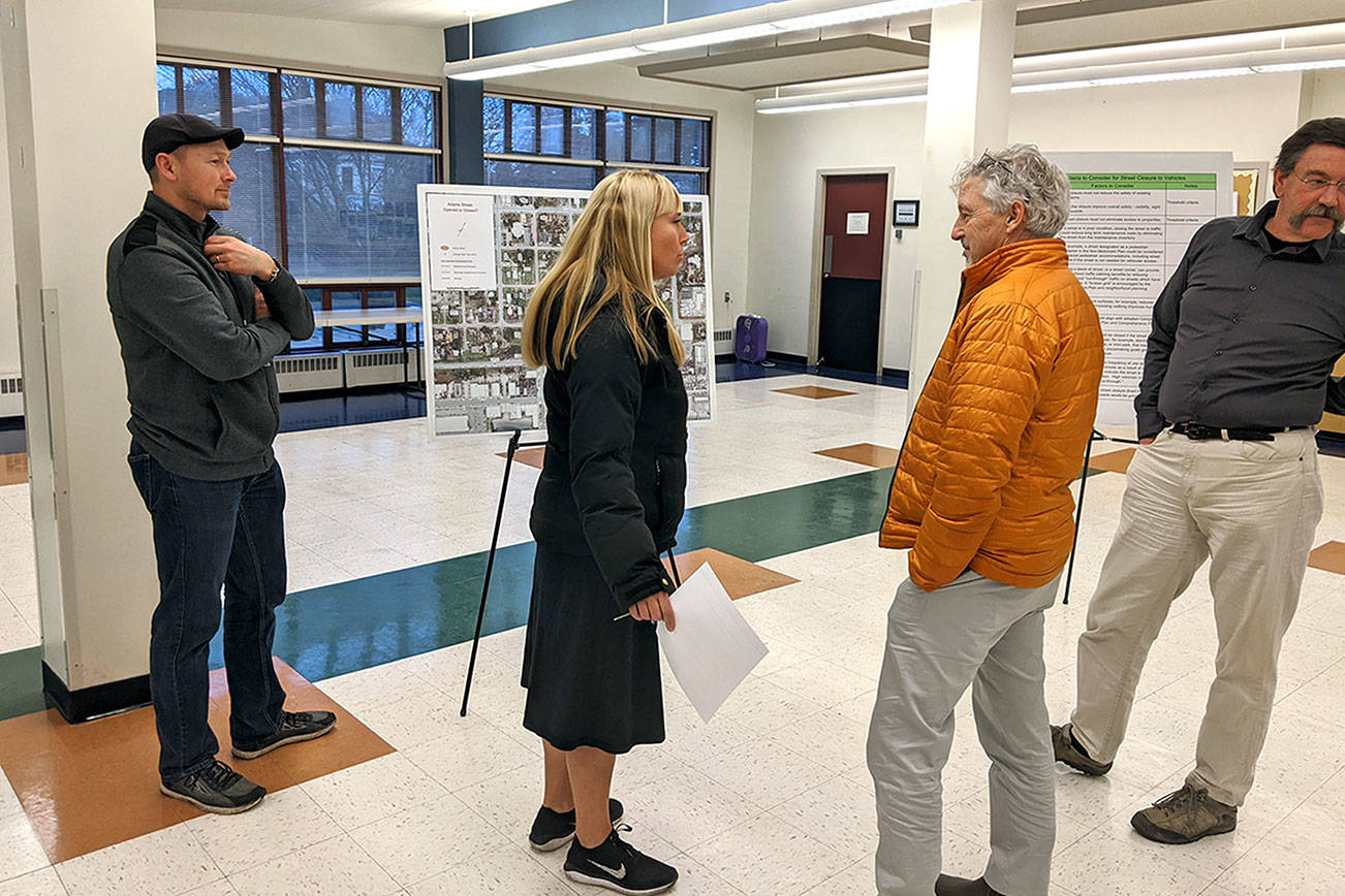 Port Townsend GIS Coordinator Tyler Johnson, left, resident Kris Nelson, interim public works director David Peterson and resident Steve Mader discuss the closure of Adams Street on Tuesday at the Port Townsend Community Center. (Zach Jablonski/Peninsula Daily News)