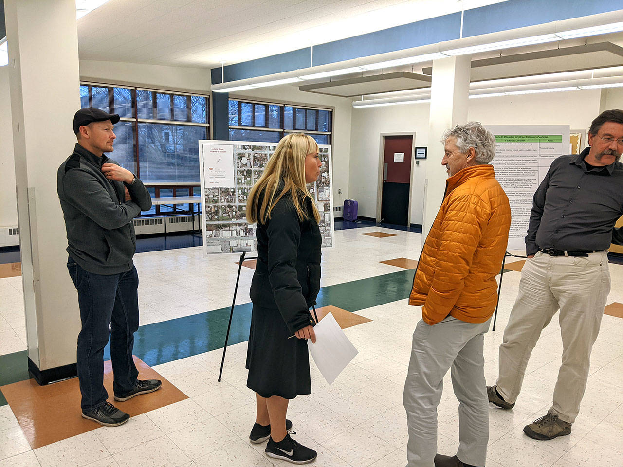 Port Townsend GIS Coordinator Tyler Johnson, left, resident Kris Nelson, interim public works director David Peterson and resident Steve Mader discuss the closure of Adams Street on Tuesday at the Port Townsend Community Center. (Zach Jablonski/Peninsula Daily News)