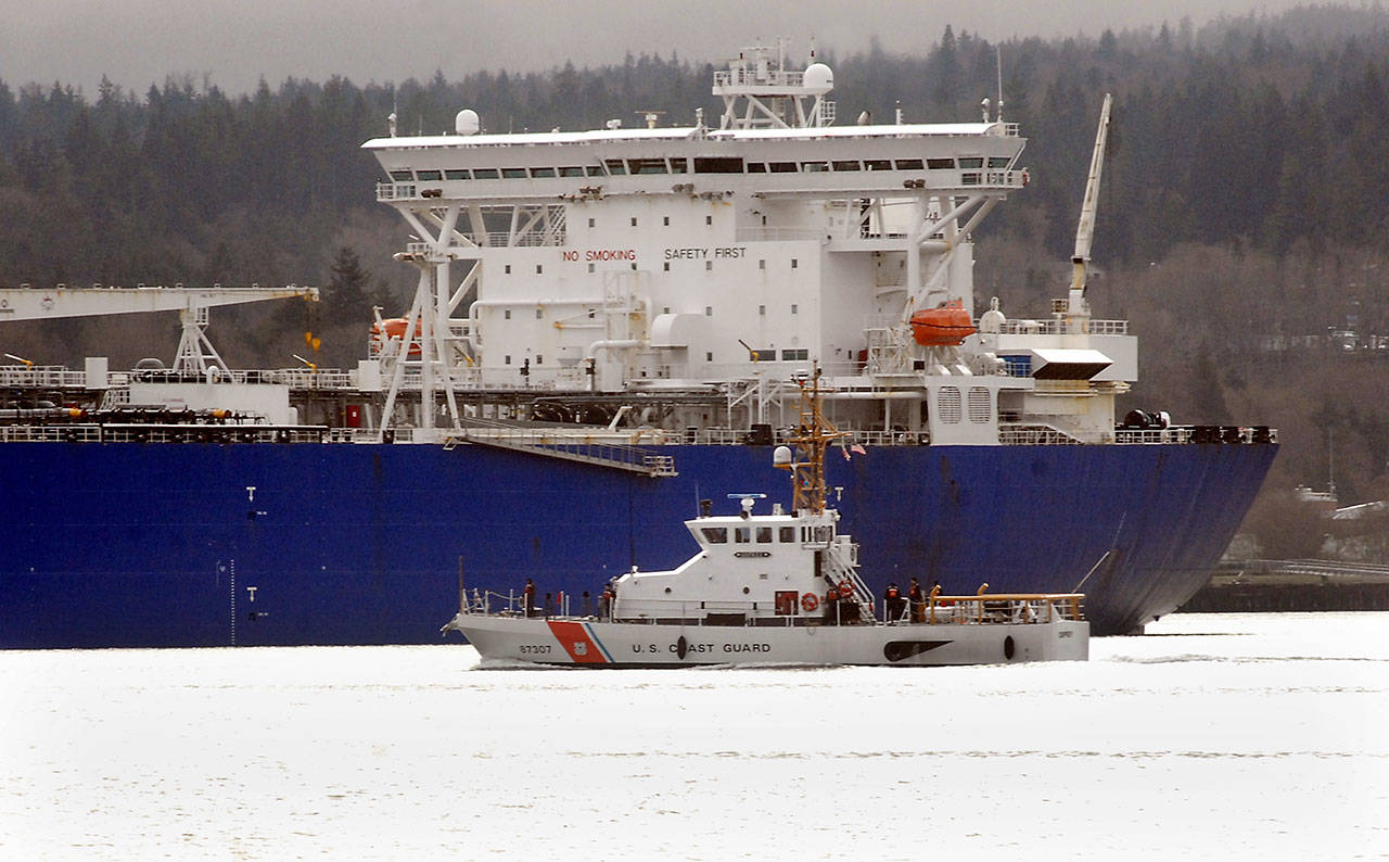 The U.S. Coast Guard Cutter Osprey sails past the tanker ship Polar Endeavour on Tuesday, March 3, 2020, in Port Angeles Harbor. (Keith Thorpe/Peninsula Daily News)