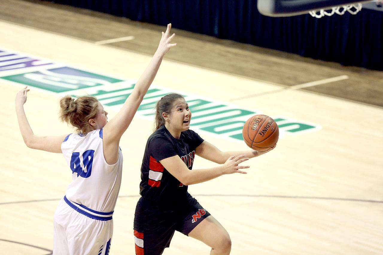 Photos by Chris Johnson/for Peninsula Daily News Neah Bay’s Ruth Moss, right, goes up for a layup during the Red Devils’ 55-53 loss to Curlew at the Class 1B Girls Basketball State Tournament at Spokane Arena on Friday.