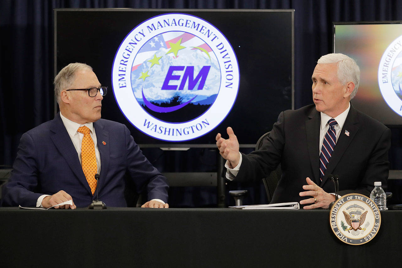 Vice President Mike Pence, right, talks with Washington Gov. Jay Inslee, left, during a meeting with officials Thursday, March 5, 2020, at Camp Murray in Washington state to discuss the state’s efforts to fight the spread of the COVID-19 coronavirus. (Ted S. Warren/The Associated Press)
