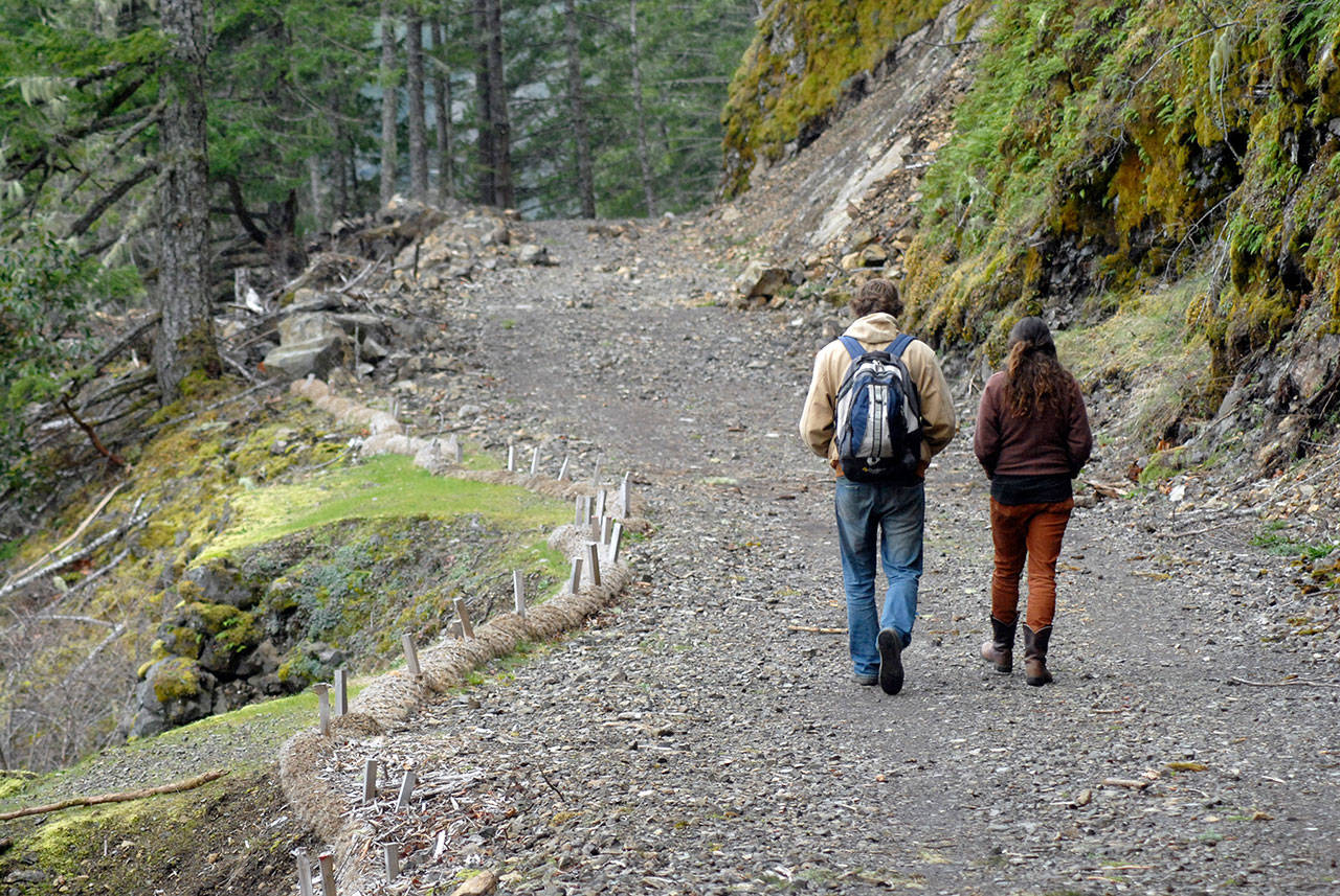 Andrew Garrard of Paradise, Calif., left, and Peri Robin of Chimacum walk along a section of the Spruce Railroad Trail around Lake Crescent on Tuesday in Olympic National Park. (Keith Thorpe/Peninsula Daily News)