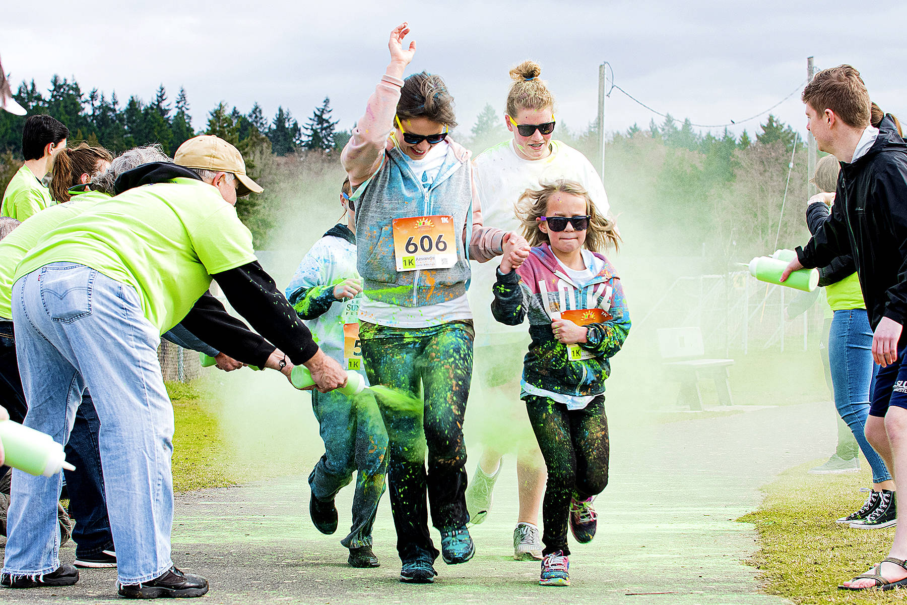 Heart and Passion Films                                Port Angeles’ Amanda and Heidi Kiddle run through the green color zone at the Sun Fun Color Run on Saturday.