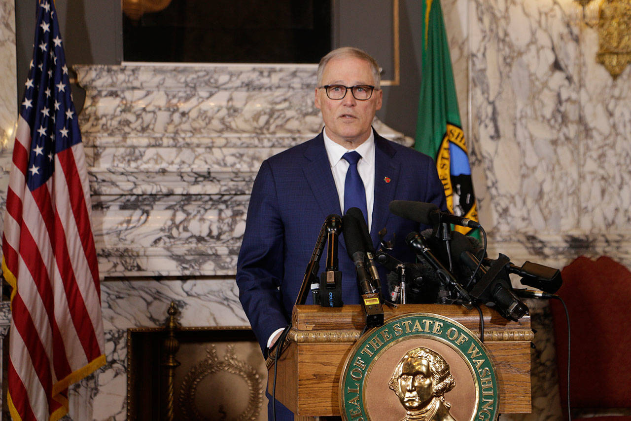 Gov. Jay Inslee talks to the media about the decision to close schools in three counties in response to COVID-19, on Thursday in Olympia. (Rachel La Corte/The Associated Press)