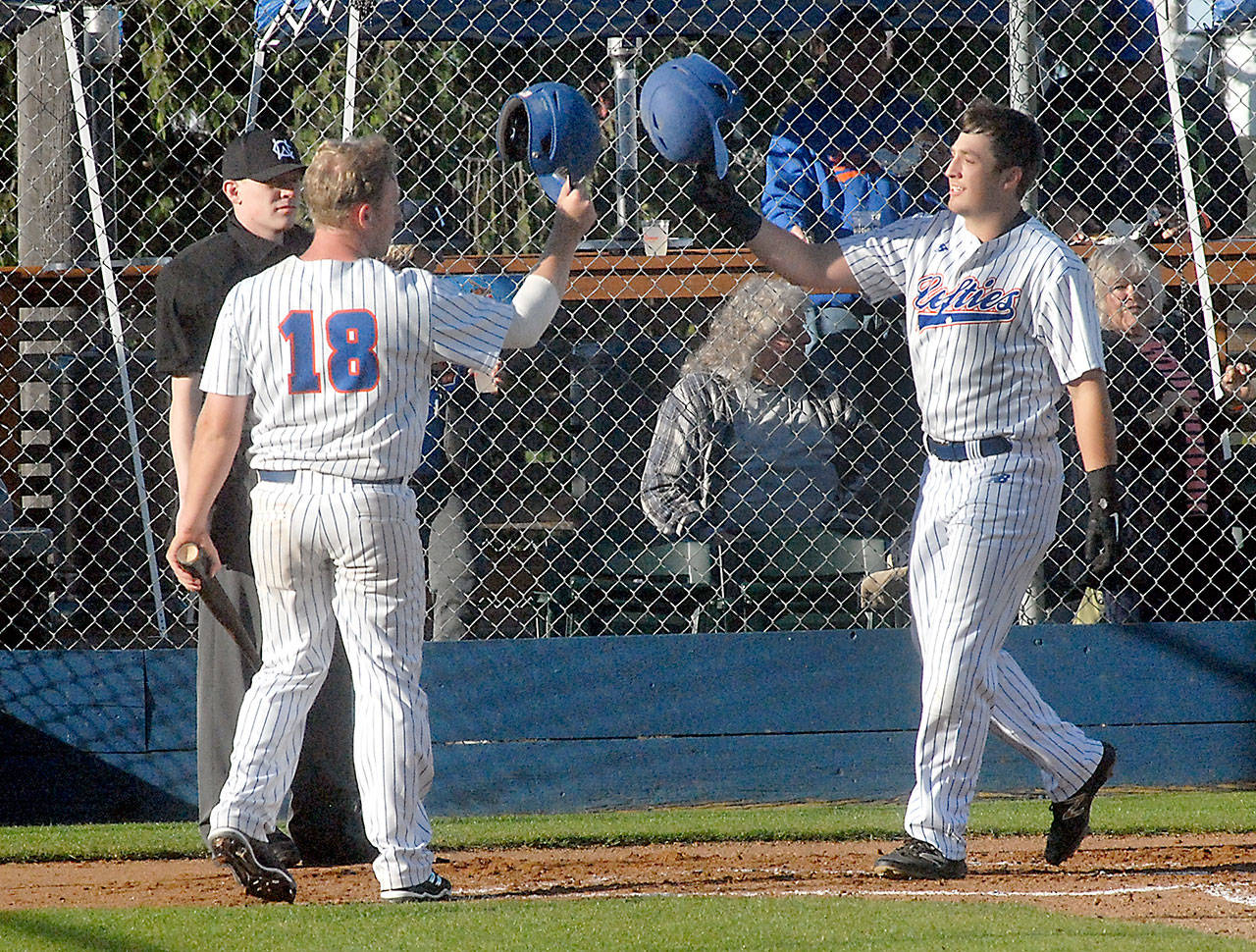 Lefties third baseman Evan Hurn, right, is greeted by fellow baserunner Zander Marco at home plate after Hurn’s two-run homer in the second inning Friday night at Port Angeles Civic Field. (Keith Thorpe/Peninsula Daily News)