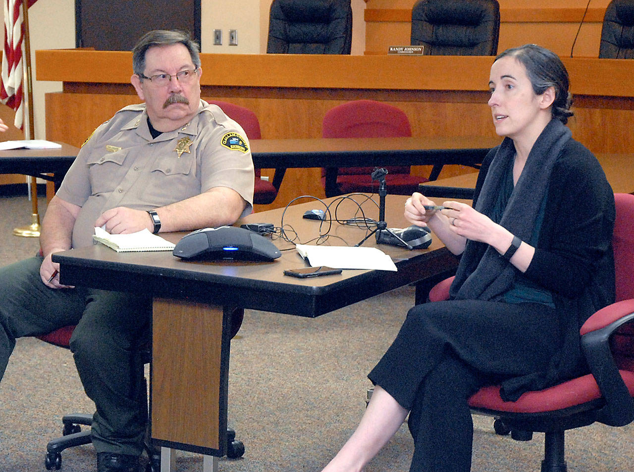 Dr. Allison Berry Unthank, Clallam County public health officer, right, provides an update on the novel coronavirus as Clallam County Undersheriff Ron Cameron listens in Tuesday, March 17, 2020, at the Clallam County Courthouse in Port Angeles. (Keith Thorpe/Peninsula Daily News)