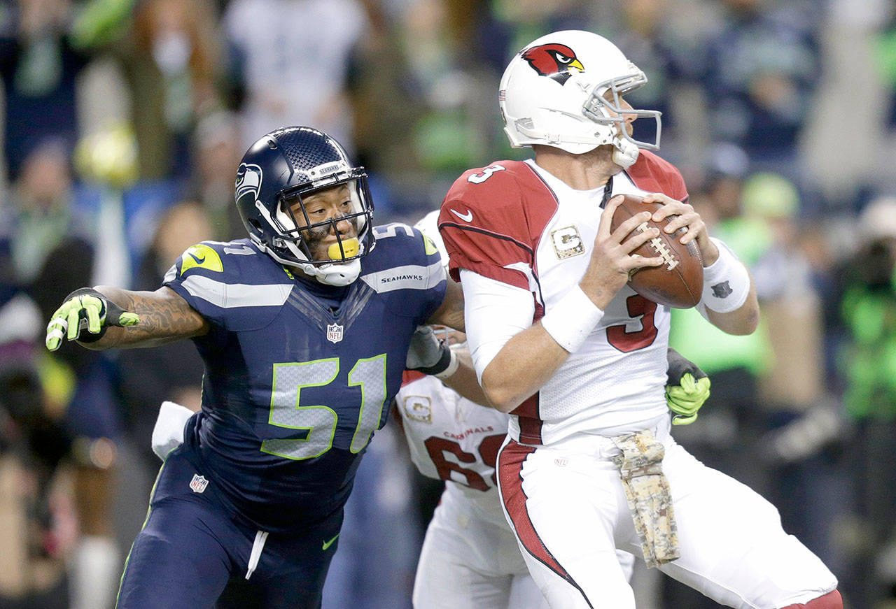 Seattle brought back former Seahawk Bruce Irvin, left, on a free-agent deal. Irvin was drafted by the team in 2012 and played for the team through 2015 before stints with the Oakland Raiders, Atlanta Falcons and Carolina Panthers. (Stephen Brashear/The Associated Press)