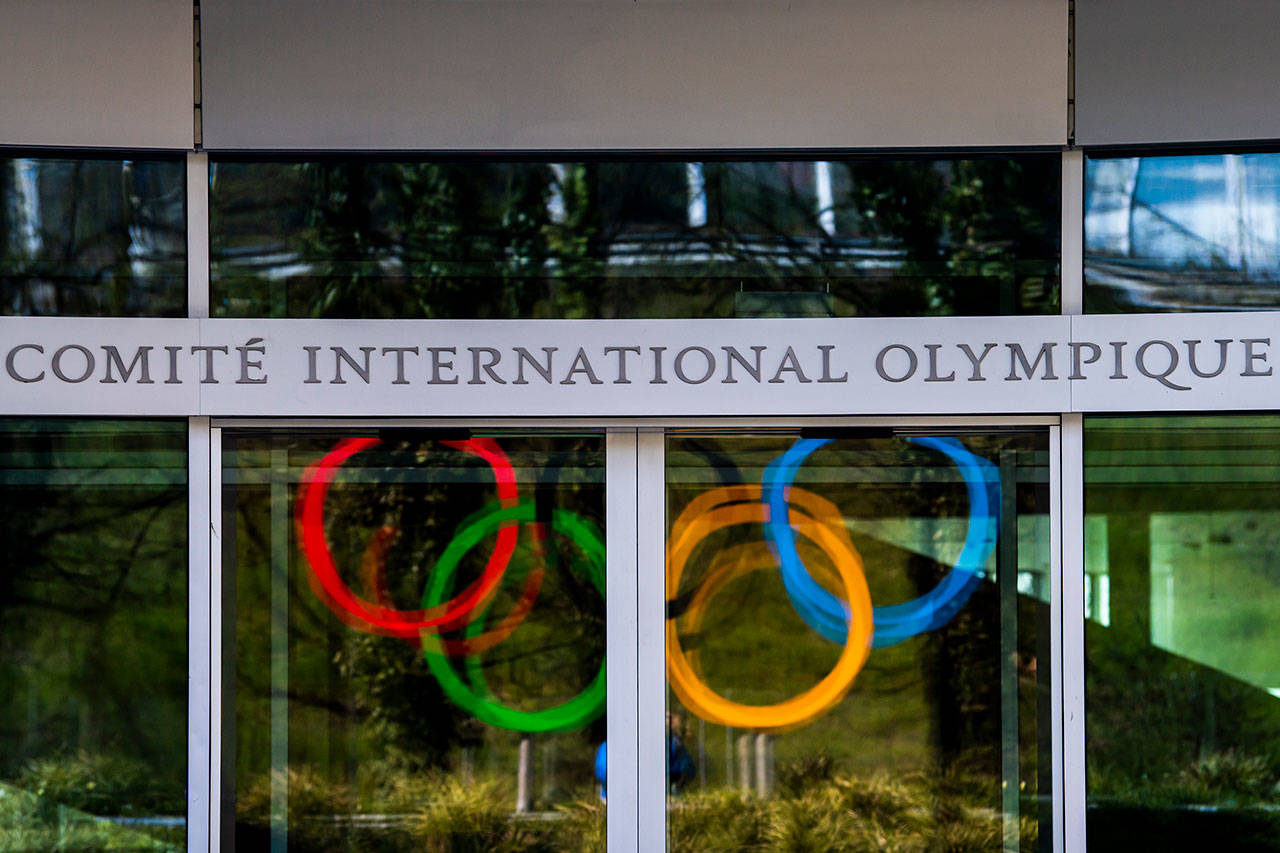 The Olympic Rings are displayed at the entrance of the IOC, International Olympic Committee headquarters during the coronavirus disease (COVID-19) outbreak in Lausanne, Switzerland, on Tuesday, March 24, 2020. (Jean-Christophe Bott/Keystone via AP)