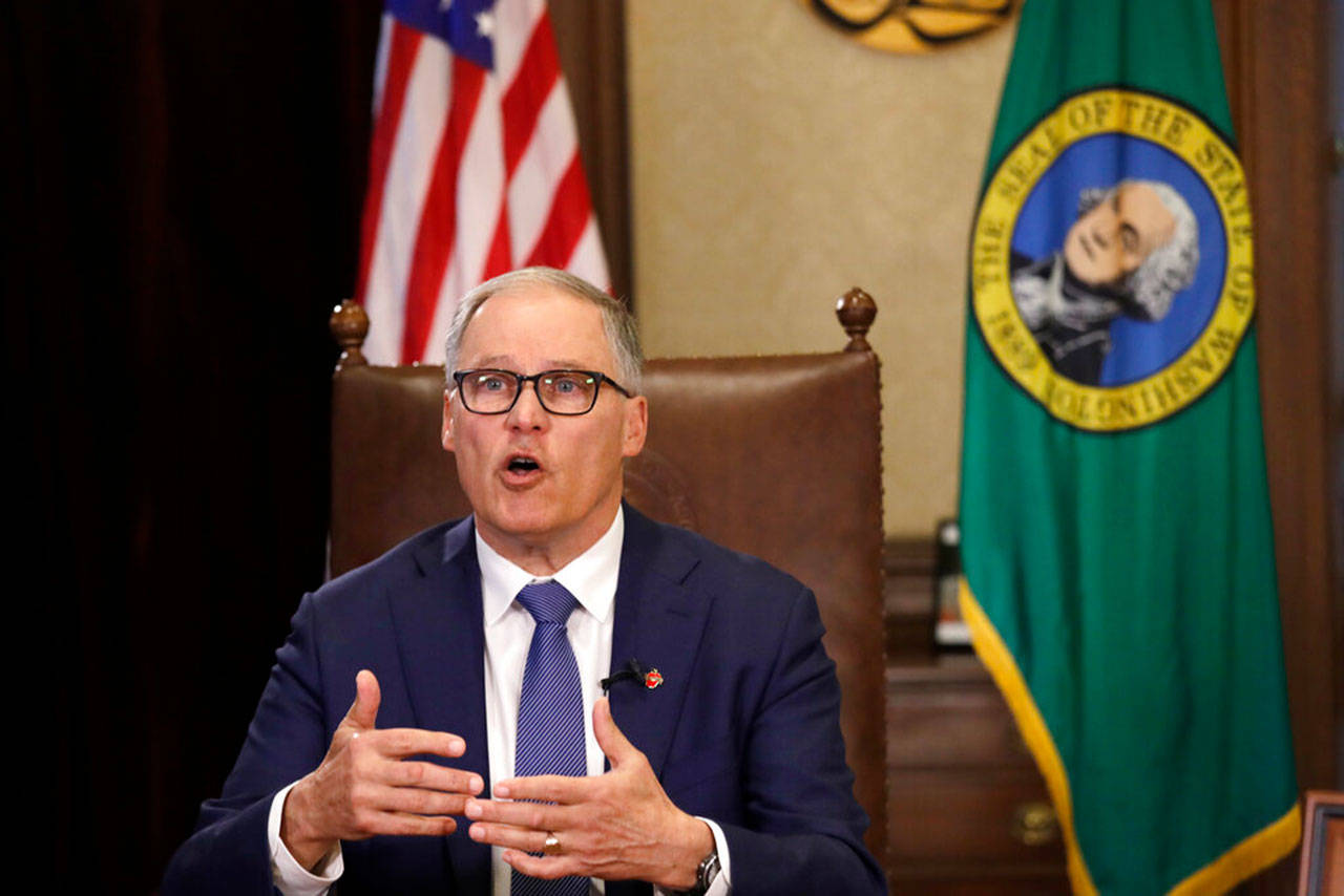 Washington Gov. Jay Inslee practices as he prepares to speak about additional plans to slow the spread of coronavirus before a televised address from his office Monday, March 23, 2020, in Olympia. Inslee has ordered non-essential businesses to close and the state’s more than 7 million residents to stay home unless necessary in order to slow the spread of COVID-19. (Elaine Thompson/The Associated Press)