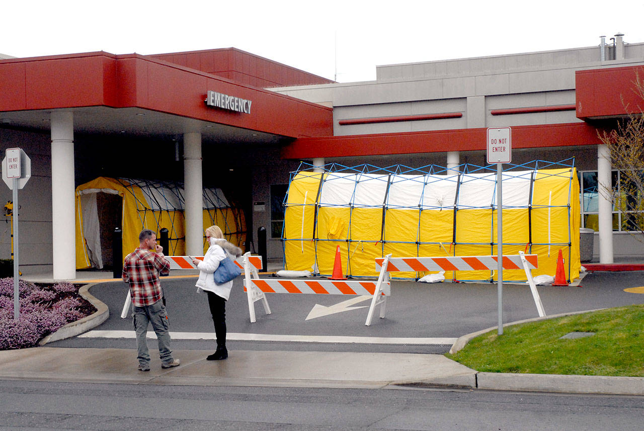 A pair of isolation tents stand at the emergency room entrance at Olympic Medical Center in Port Angeles on Tuesday, March 24, 2020, in response to possible cases of COVID-19. (Keith Thorpe/Peninsula Daily News)