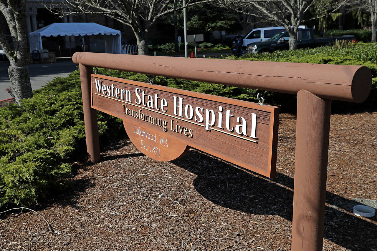 A sign near an entrance to Western State Hospital is shown Thursday, March 19, 2020, in Lakewood. A patient and a worker at the facility, Washington state’s largest psychiatric hospital, have tested positive for the new coronavirus. The tent shown behind the sign will eventually be used for screening employees for symptoms of the virus as they arrive for work. (Ted S. Warren/The Associated Press)