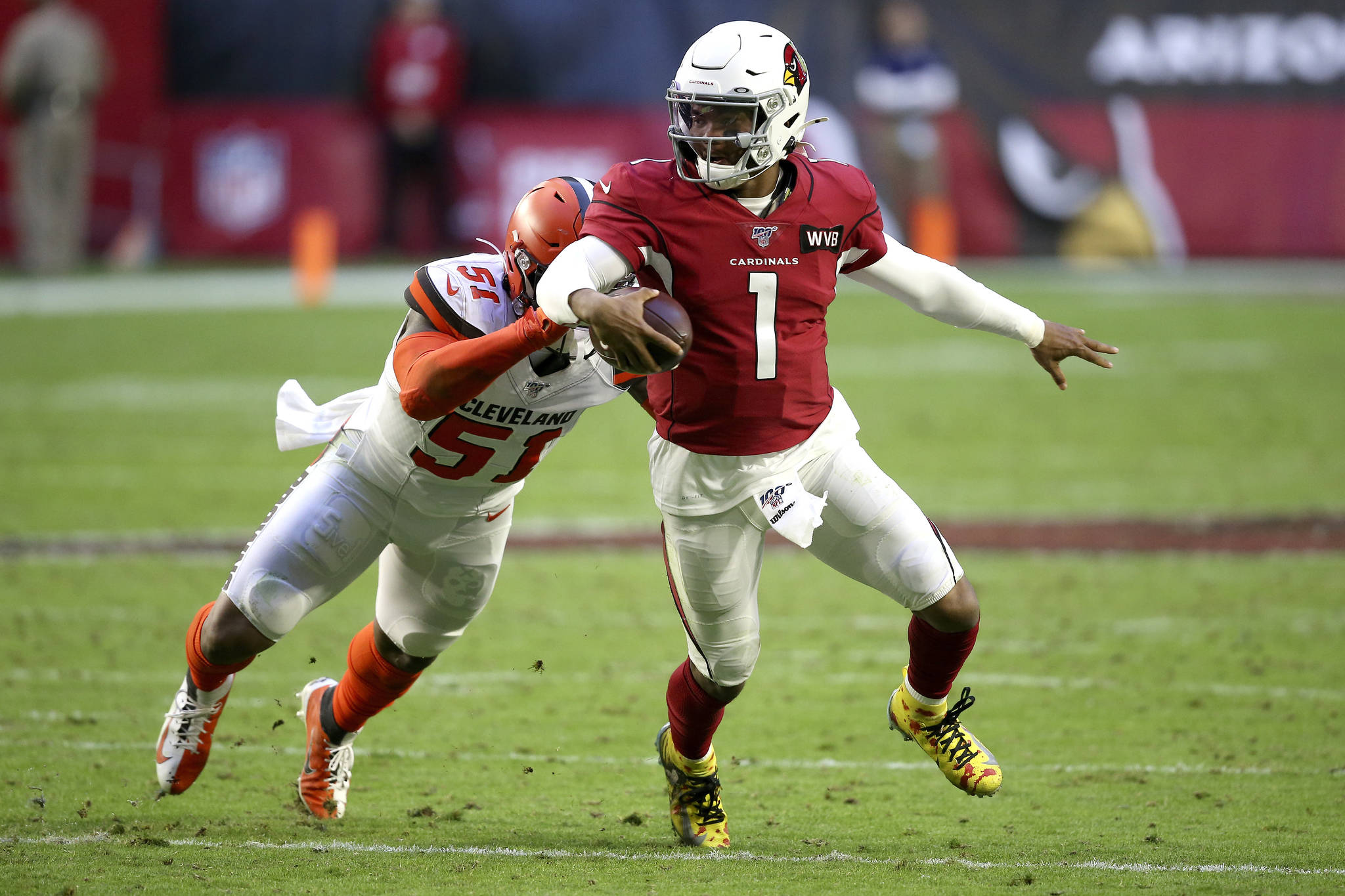 FILE - In this Dec. 15, 2019, file photo, Arizona Cardinals quarterback Kyler Murray (1) gets away from Cleveland Browns linebacker Mack Wilson (51) during the second half of an NFL football game in Glendale, Ariz. Coach Kliff Kingsbury and the Cardinals went 5-10-1 last year, but they’re a popular pick to improve sharply this year. (AP Photo/Ross D. Franklin, File)