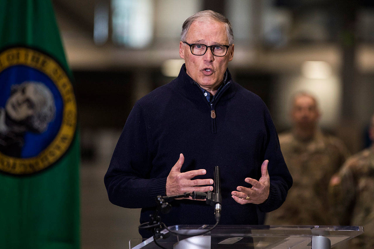 Gov. Jay Inslee discusses the deployment of a field hospital at CenturyLink Field Event Center on Saturday, March 28, 2020, in Seattle, Wash. This field hospital is expected to create at least 150 hospital beds for non-COVID-19 cases. (Amanda Snyder/The Seattle Times via AP, Pool)