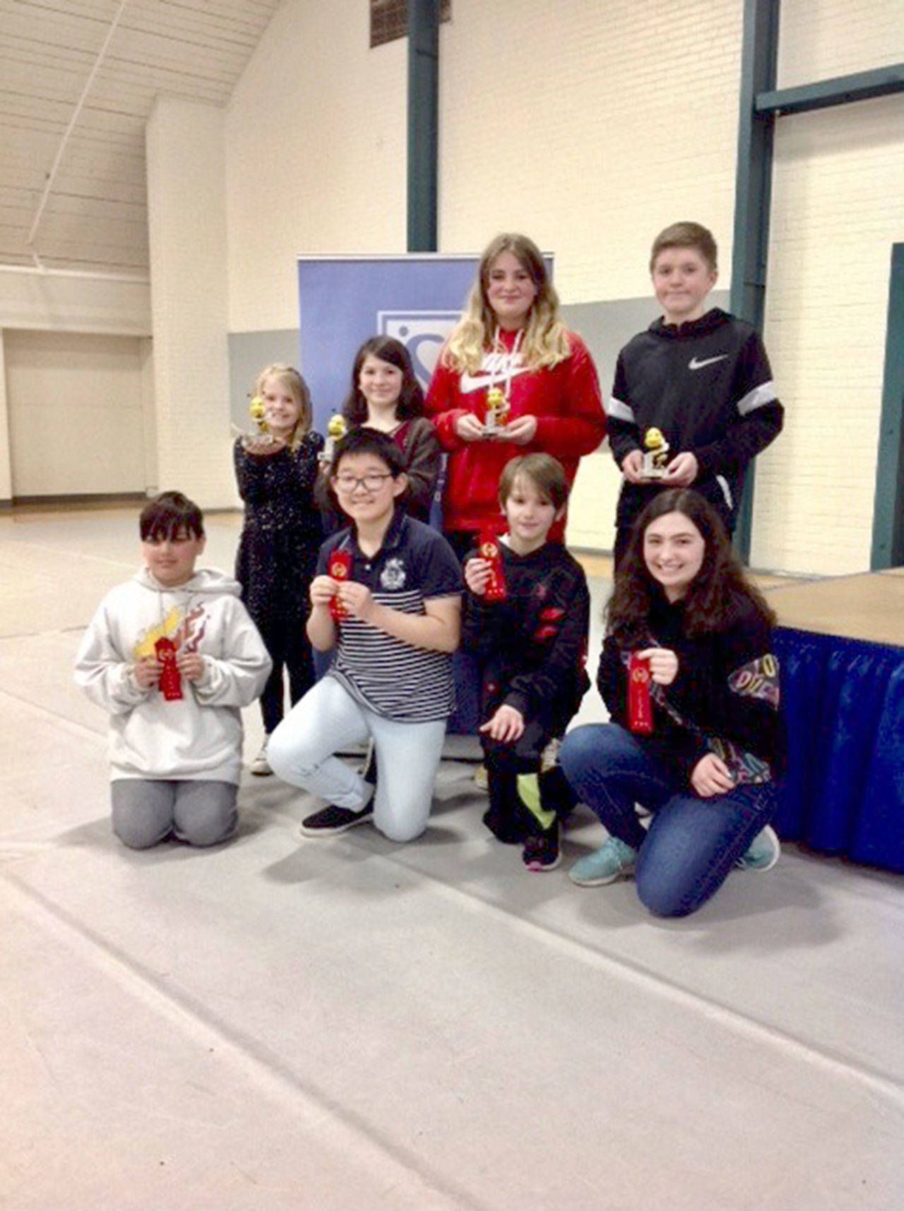Winners of this year’s Soroptimist Spelling Bee, standing from left to right are Mya Callis, Miriam Cobb, Kylie Brandt and Liam McBride. Kneeling in the front, from left to right are second-place winners Chase Wojnowski, Nicky Park, Cade Whitaker and Allison Broadwell. (Photo by Patty Rosand)