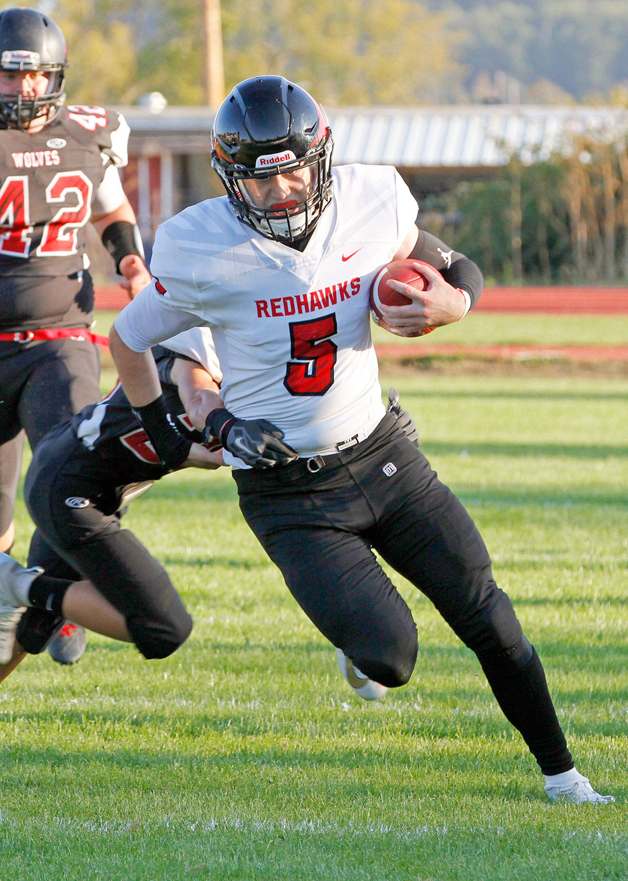 Port Townsend senior Noa Apker-Montoya runs with the football during the Redhawks 49-16 win over Coupeville last Fall. Apker-Montoya was a four-year starter on the Port Townsend football and basketball teams and also played baseball and golf. (Lisa Jensen)