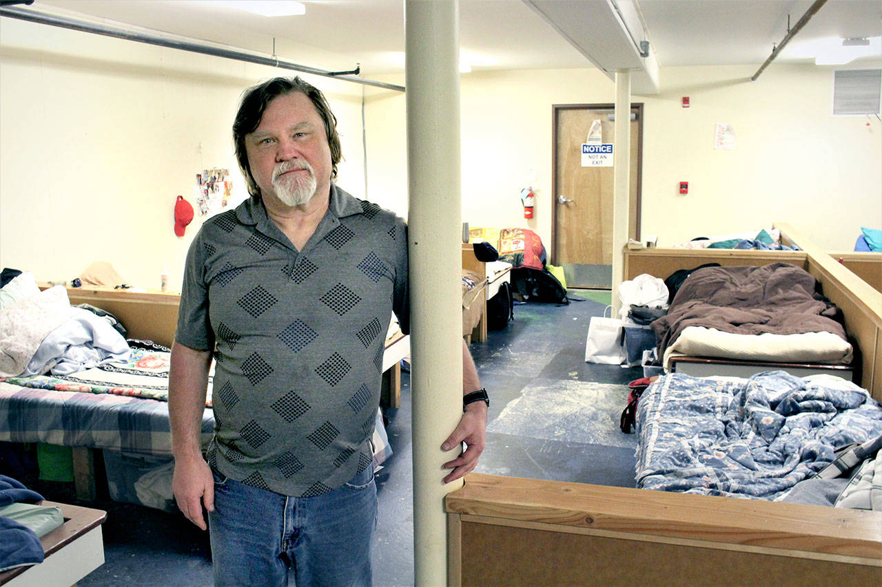 Port Townsend homeless shelter manager Mike Johnson stands in the men’s sleeping area of the shelter at the American Legion in Port Townsend on Tuesday, April 7, 2020. Olympic Community Action Programs will shift from congregate housing to individual housings in the community beginning Monday. (Zach Jablonski/Peninsula Daily News)