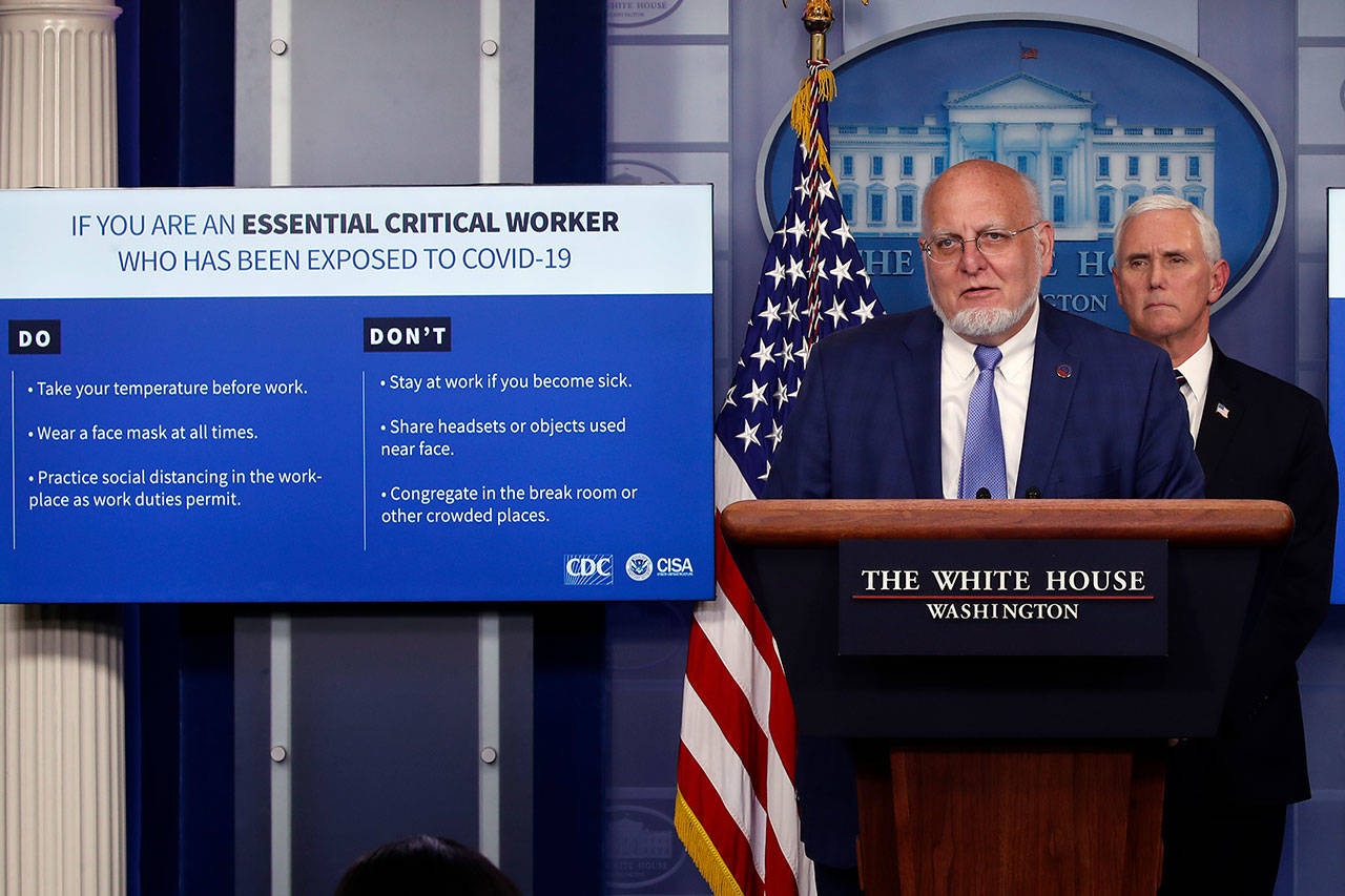 Dr. Robert Redfield, director of the Centers for Disease Control and Prevention, speaks as charts are displayed during a briefing about the coronavirus in the James Brady Press Briefing Room of the White House on Wednesday, April 8, 2020, in Washington, as Vice President Mike Pence listens. (Alex Brandon/The Associated Press)
