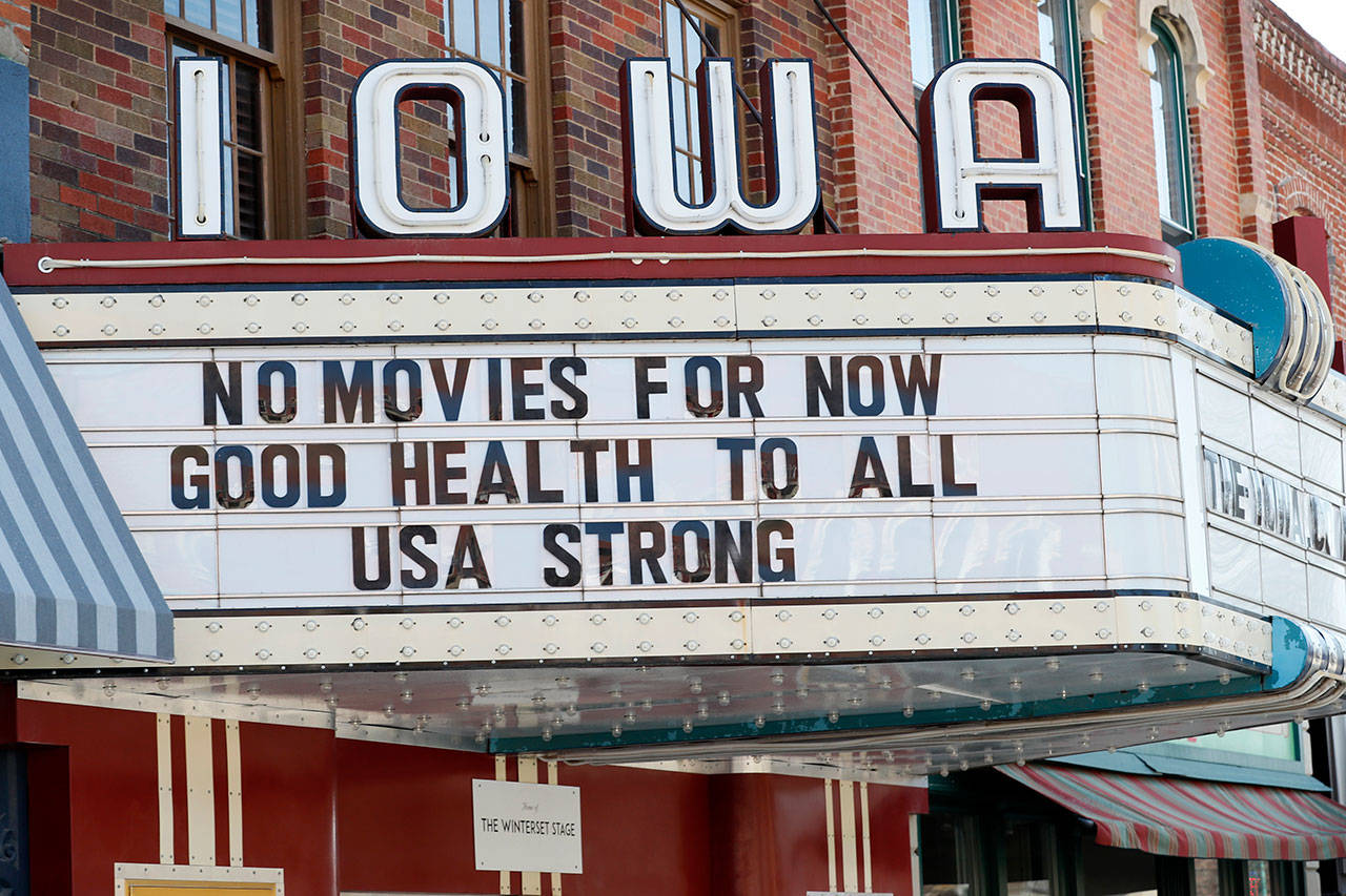 The marquee for the Iowa Theater, closed in response to the coronavirus outbreak, is seen on John Wayne Drive on Wednesday, April 1, 2020, in Winterset, Iowa. The new coronavirus causes mild or moderate symptoms for most people, but for some, especially older adults and people with existing health problems, it can cause more severe illness or death. (AP Photo/Charlie Neibergall)