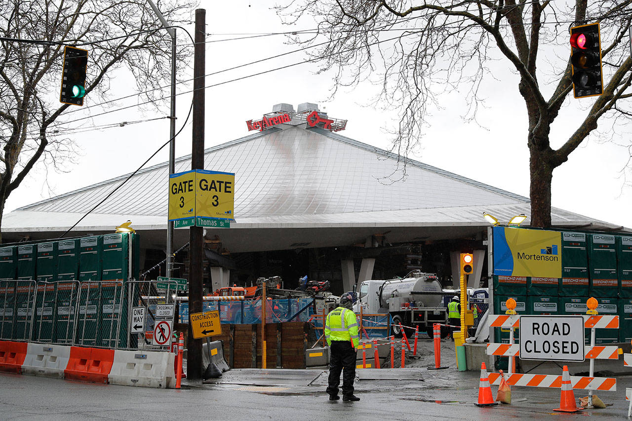 In this March 30, 2020, photo, KeyArena is shown with renovation construction resumed after being temporarily halted due to the outbreak of the coronavirus. The pandemic has created questions of scheduling and worker health as eight stadiums or arenas are under construction or about to break ground in the five major professional sports leagues in North America. The facility is the home of the WNBA Seattle Storm, and will be the home of Seattle’s expansion NHL team, which is scheduled to begin play in the 2021-22 season. (Ted S. Warren/The Associated Press)