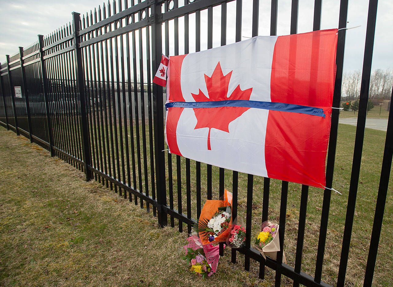 A tribute is displayed Monday, April 20, 2020, at the Royal Canadian Mounted Police headquarters in Dartmouth, Nova Scotia, following a weekend shooting rampage by a gunman, disguised as a police officer, that killed multiple people including an RCMP constable. (Andrew Vaughan/The Canadian Press via AP)