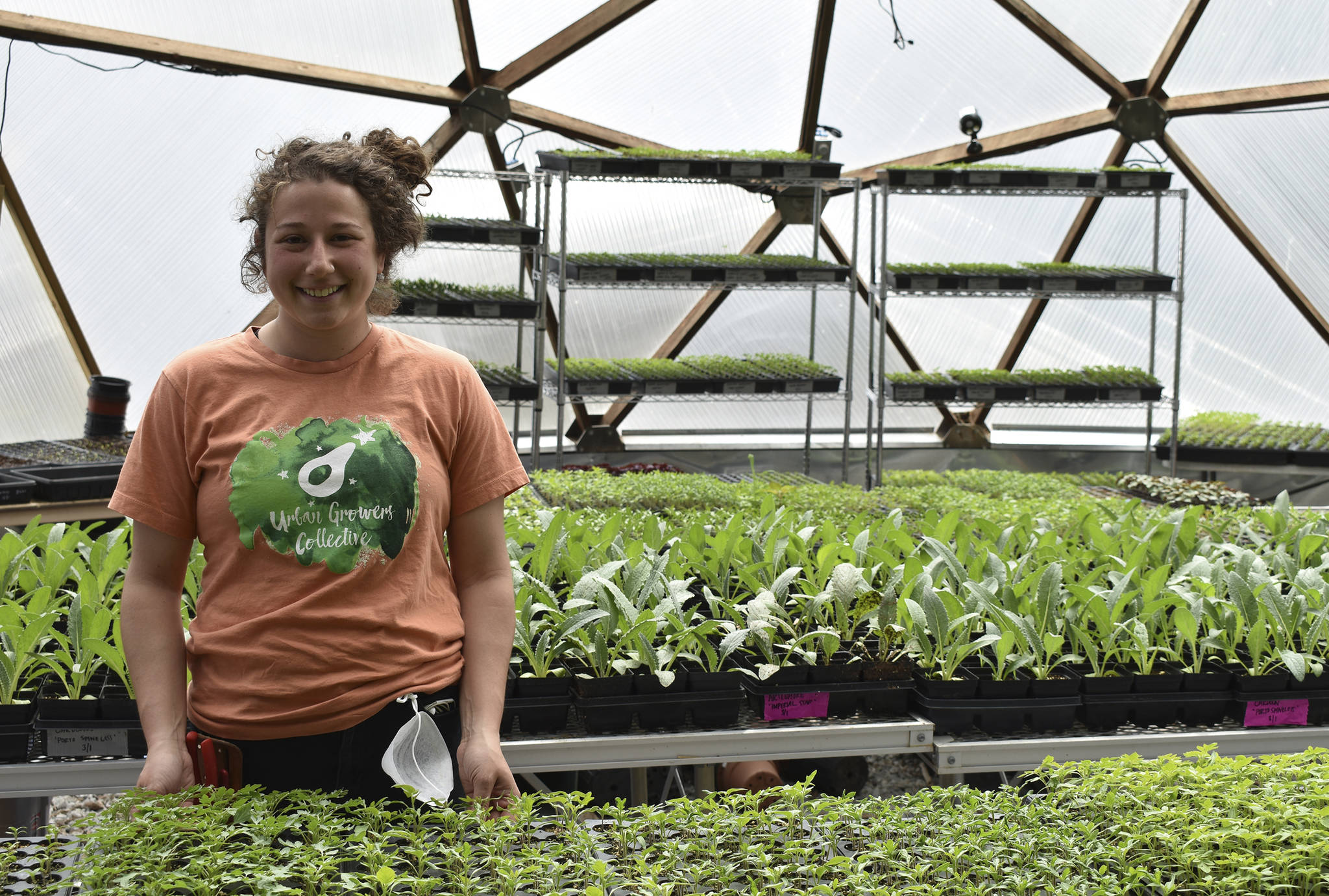 This April 10, 2020, photo shows Allison Sturm, Urban Farm Assistant, at the Urban Growers Collective farm in Chicago. The nonprofit teaches young kids and others to grow vegetables at eight urban farms around the city. While their spring educational programs are on hold due to rules on social distancing, Laurell Sims, the co-founder, said they are still focusing on food production and getting produce to families that need it. (Laurell Sims via AP)