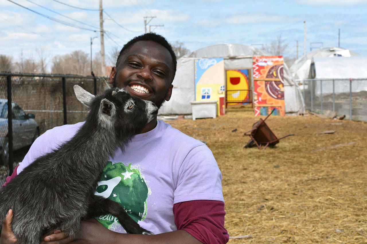 This April 10, 2020, photo shows Marshall Mitchell, Urban Farm Assistant at the Urban Growers Collective farm in Chicago. The nonprofit teaches young kids and others to grow vegetables at eight urban farms around the city. While their spring educational programs are on hold due to rules on social distancing, Laurell Sims, the co-founder, said they are still focusing on food production and getting produce to families that need it. (Laurell Sims via AP)