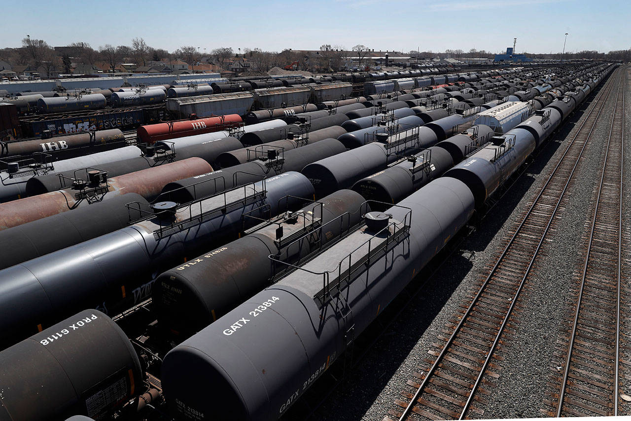 Oil tank train cars sit idle Tuesday, April 21, 2020, in East Chicago, Ind. The world is awash in oil, there’s little demand for it and we’re running out of places to put it. That in a nutshell explains this week’s strange and unprecedented action in the market for crude oil futures contracts, where traders essentially offered to pay someone else to deal with the oil they were due to have delivered next month. (Charles Rex Arbogast/The Associated Press)